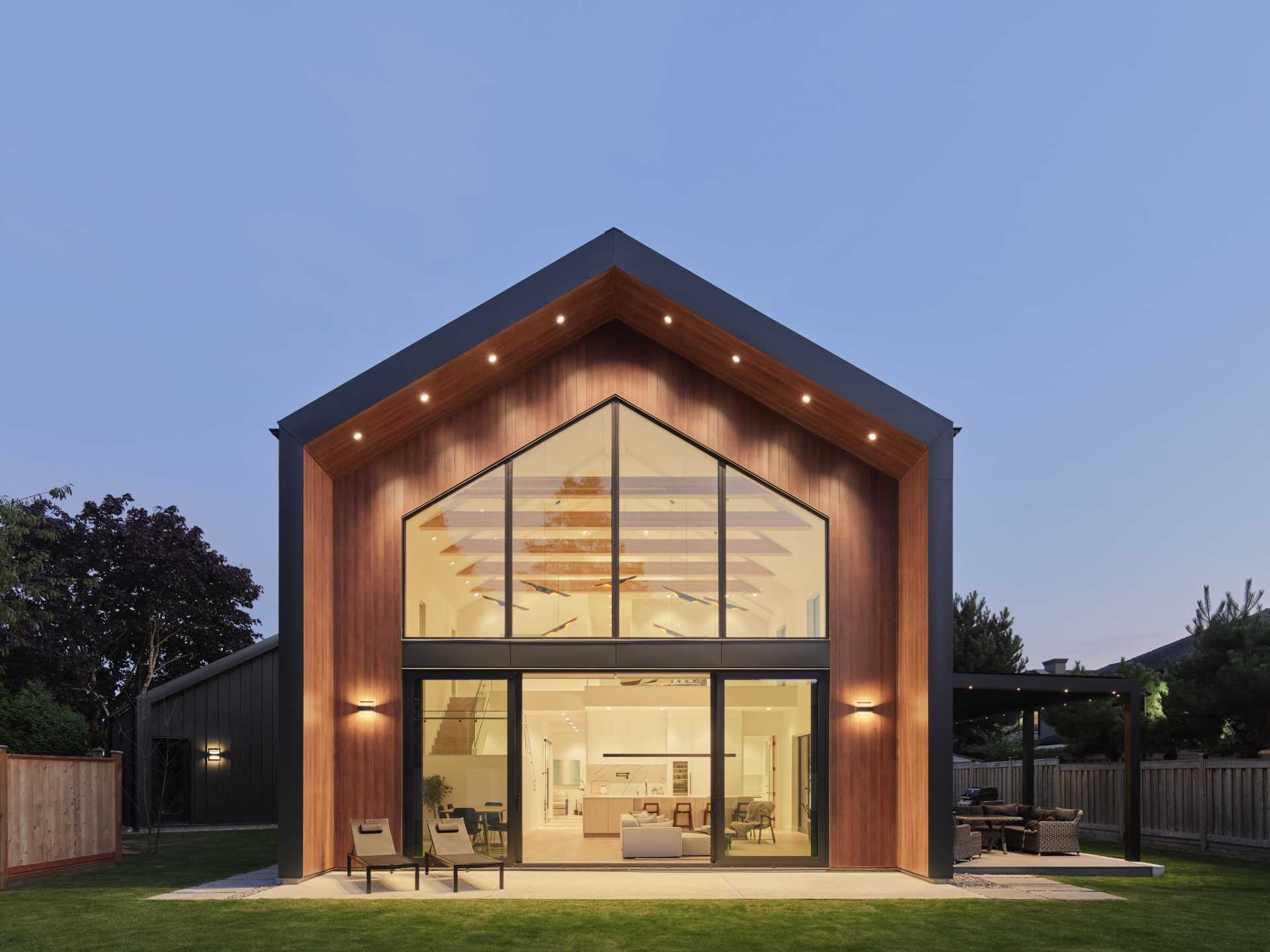 A modern barn house features a vaulted ceiling that reaches a peak height of 25 feet (7m).