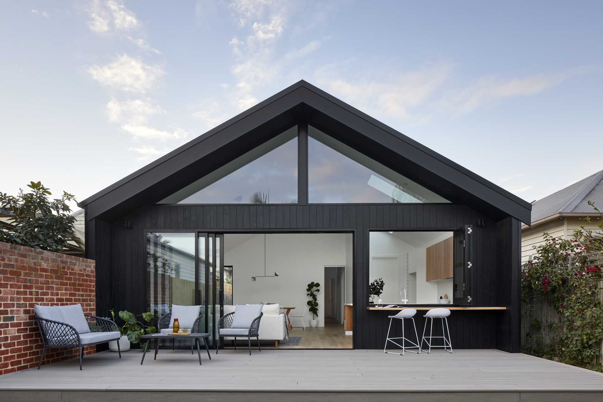 A modern rear house addition that includes a pass-through window.