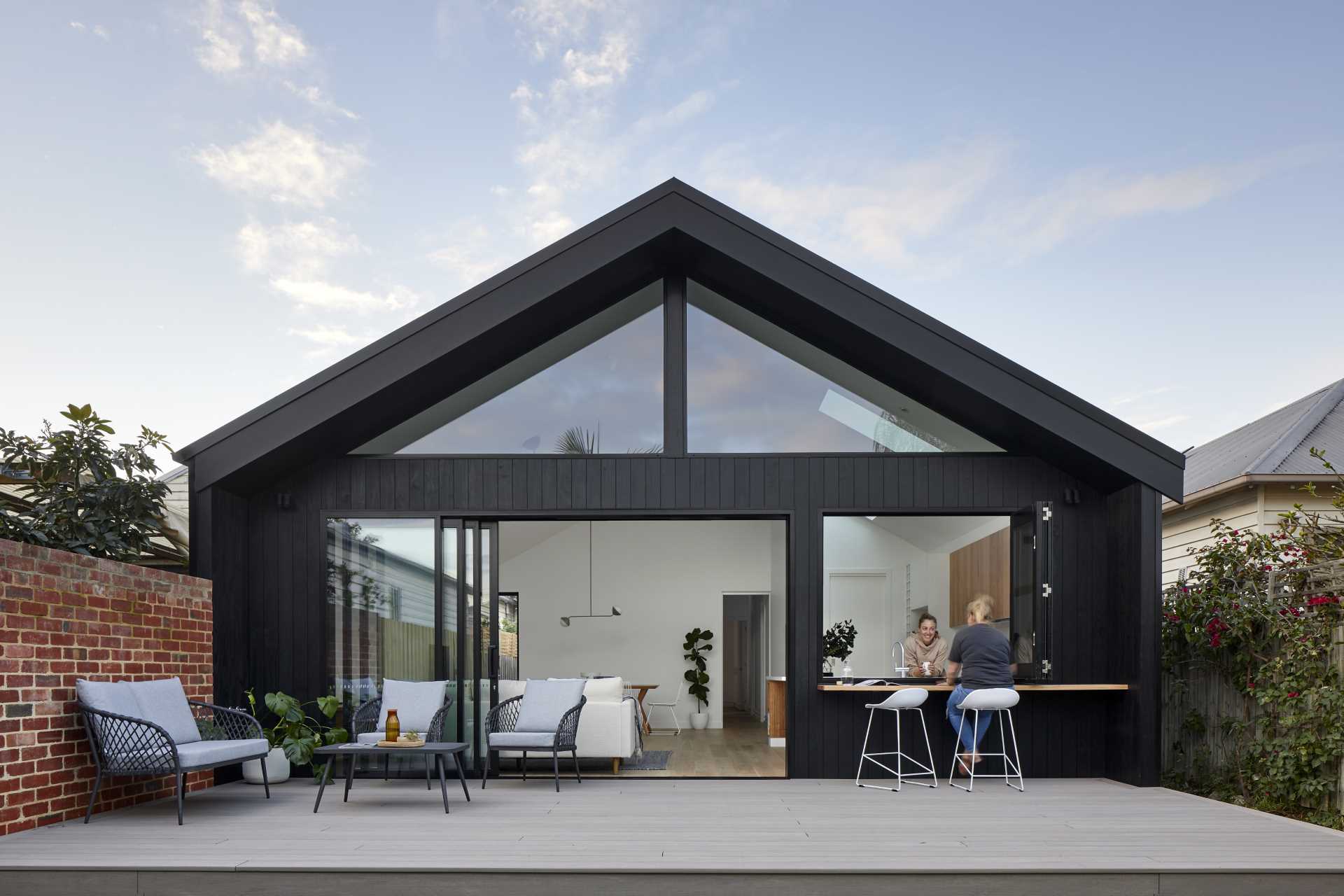 A modern rear house addition that includes a pass-through window.