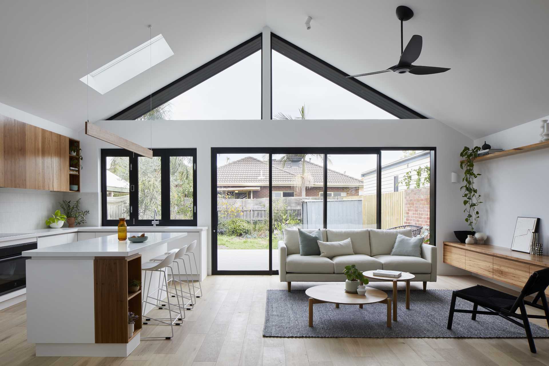 The open floor plan of this rear home addition has one side dedicated to the kitchen, other the other side is the living room.