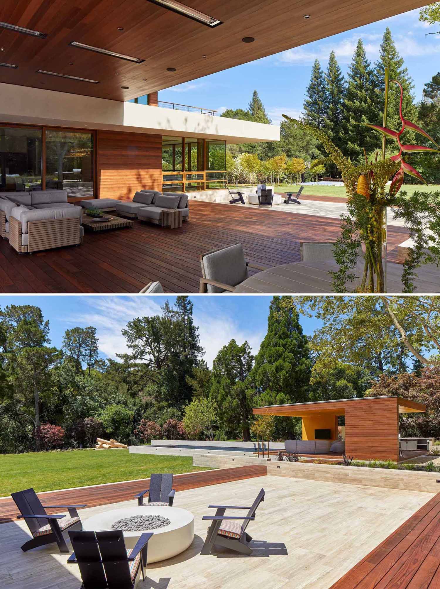 At the rear of this modern home, there's a large covered porch with an outdoor lounge and dining area, as well as a nearby firepit.