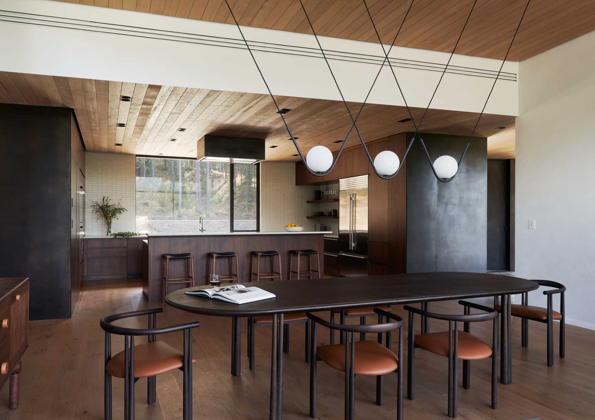 A modern kitchen with dark walnut cabinets and white countertops.