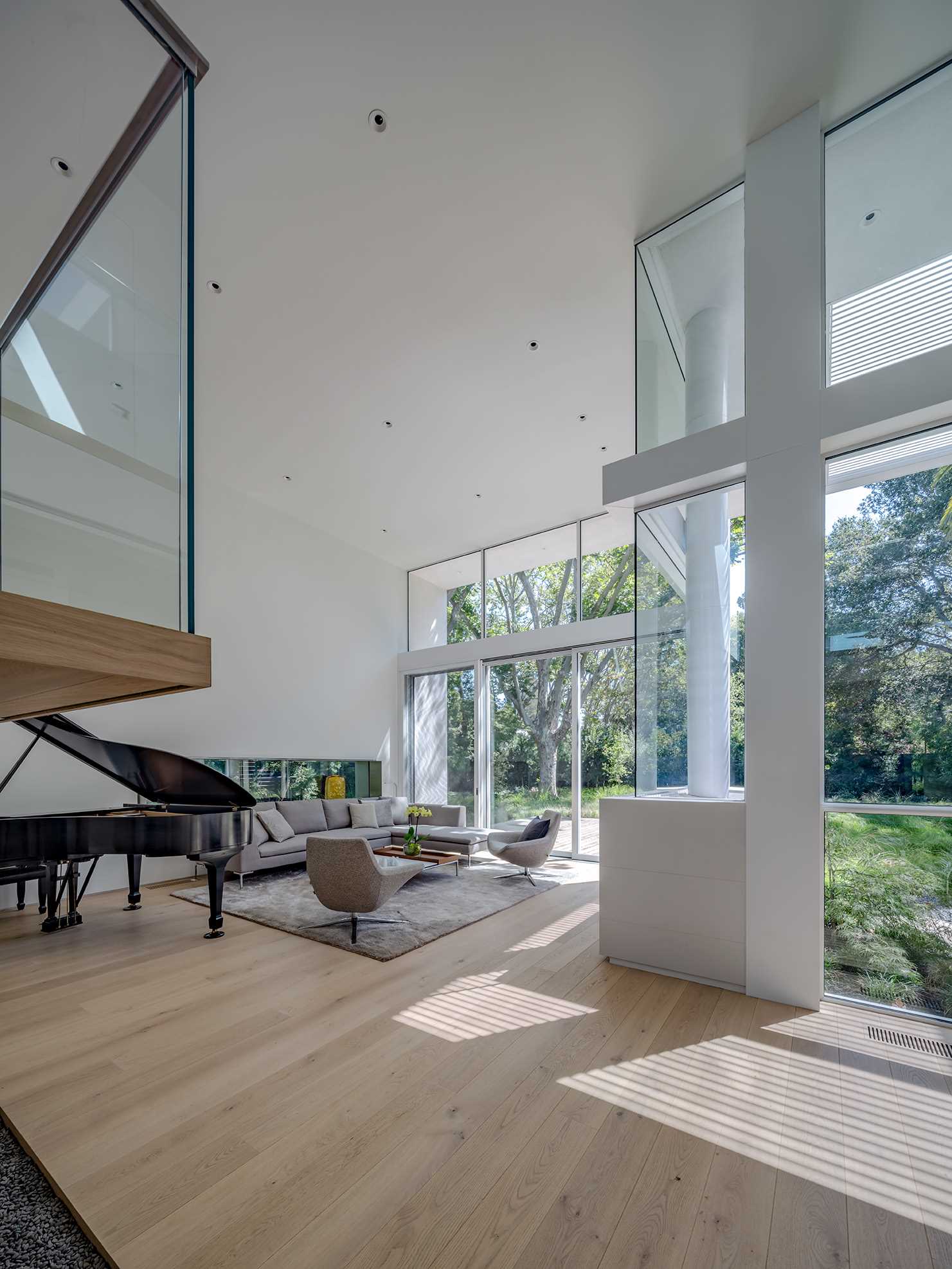 This modern living room has a horizontal window and a matching horizontal fireplace on the opposite wall. There's also a sliding glass door that opens to the yard.