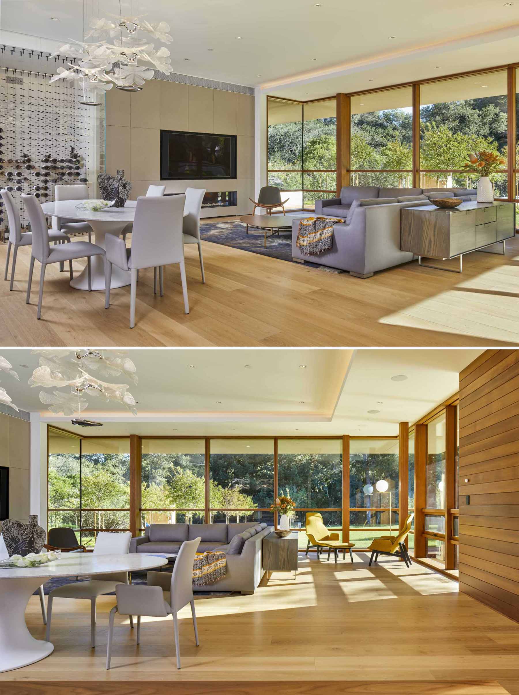 A modern family room and dining area that look out to the yard.