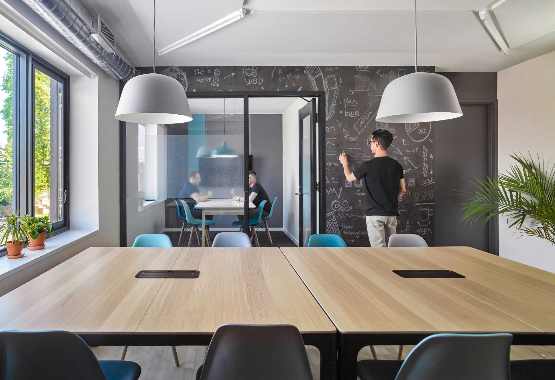 The chalkboard wall in this collaboration space allows members to leave messages or brainstorm ideas away from a computer screen.