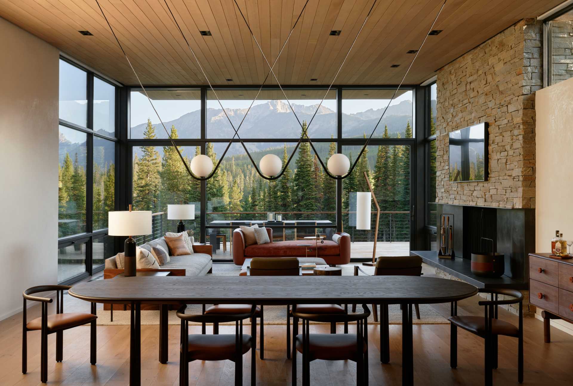 A modern open plan dining room with eye-catching lighting above the table.