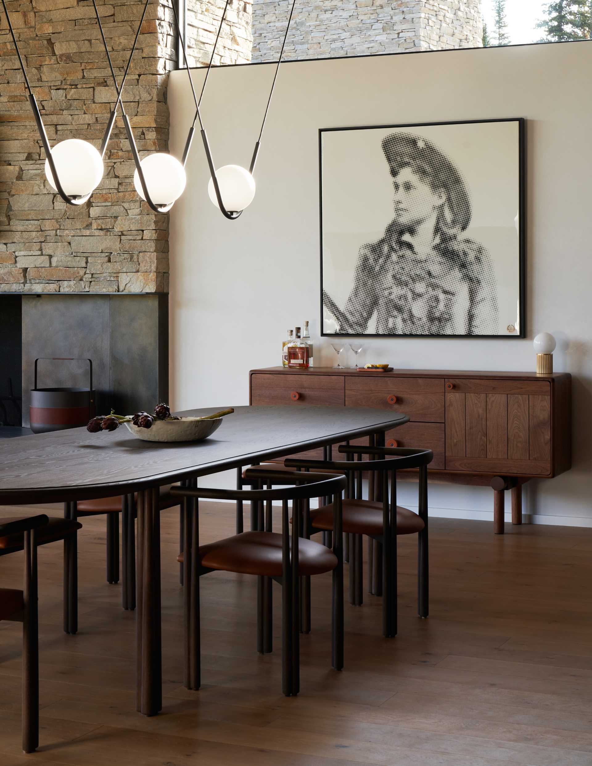 A modern open plan dining room with eye-catching lighting above the table.