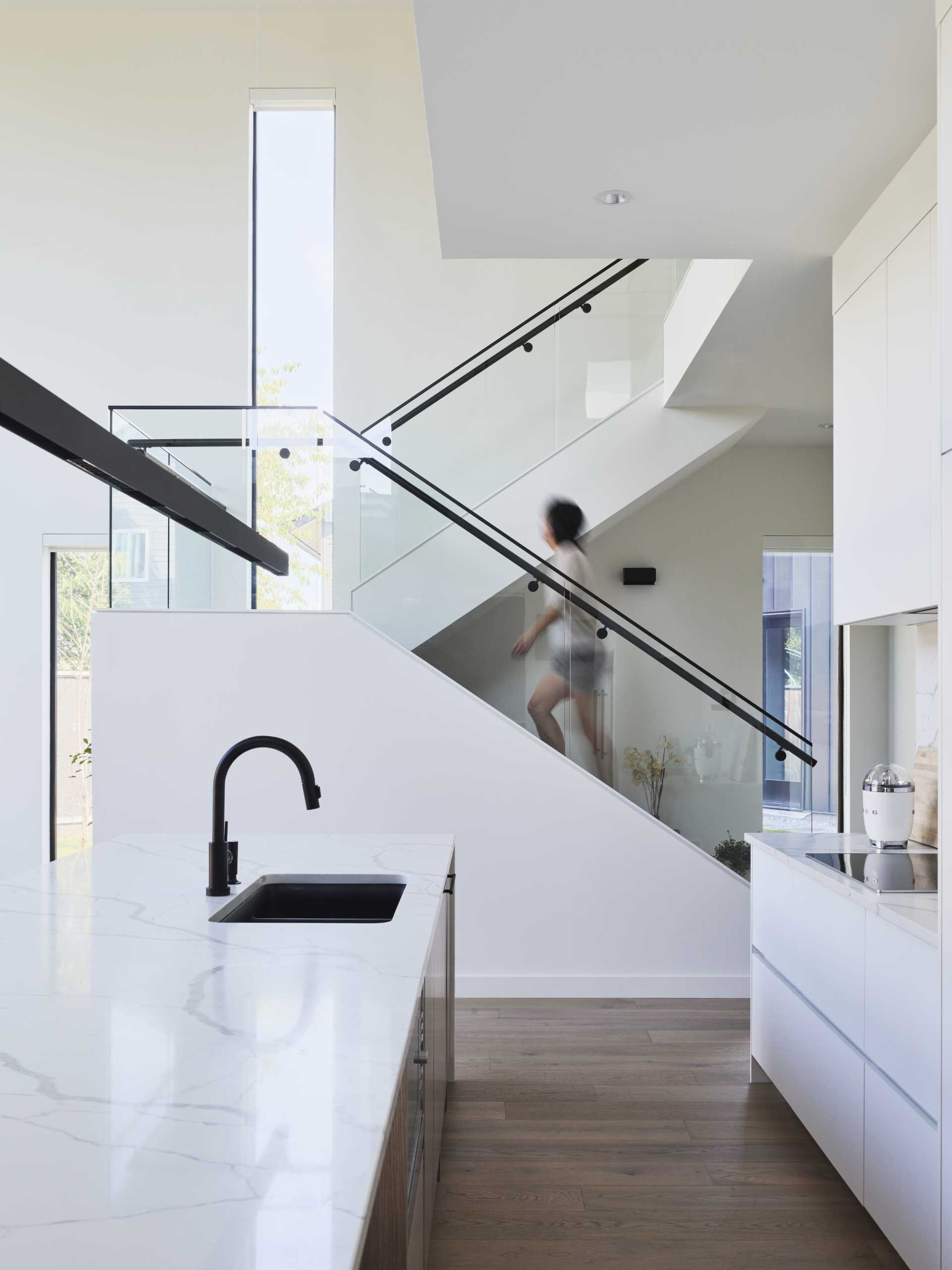 An open staircase leads to the second floor, providing an overlook of the living areas below. The mezzanine provides a place to relax and study while still feeling connected to the rest of the house.