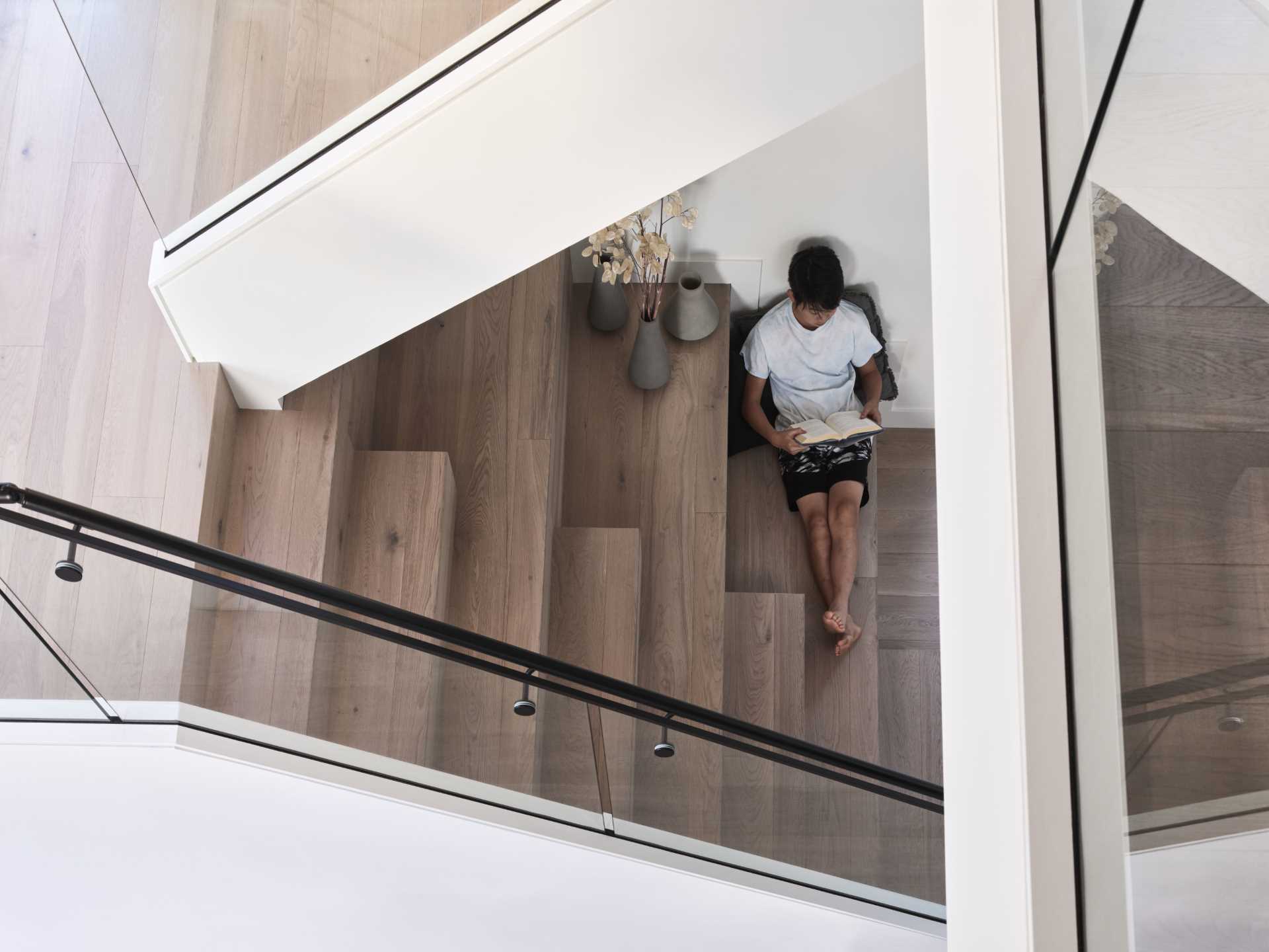 An open staircase leads to the second floor, providing an overlook of the living areas below. The mezzanine provides a place to relax and study while still feeling connected to the rest of the house.