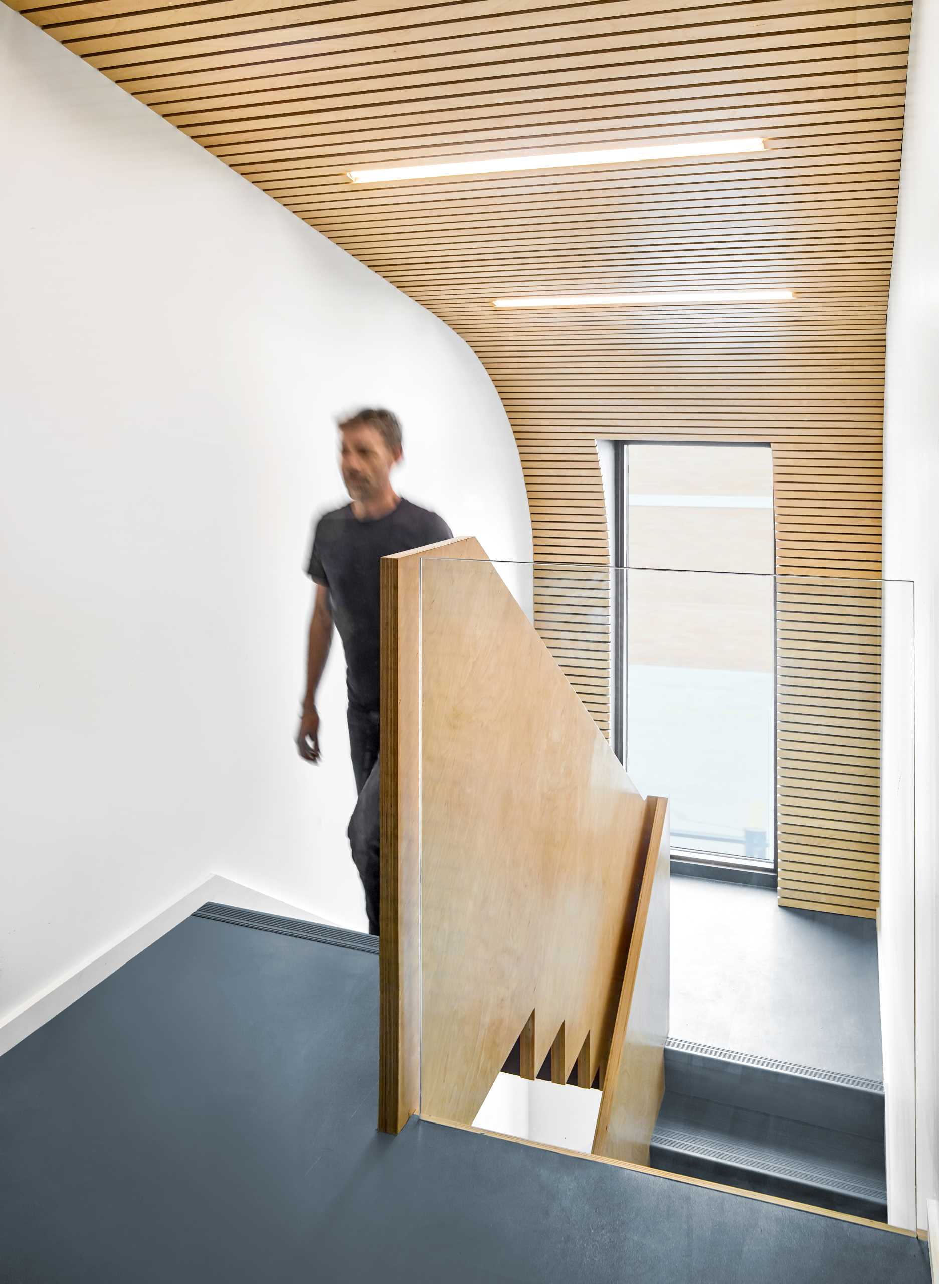 The central staircase thematically connects all floors in this office building with Baltic birch slats and graphic floor numbers that lead to Dubbeldam’s top-floor studio.