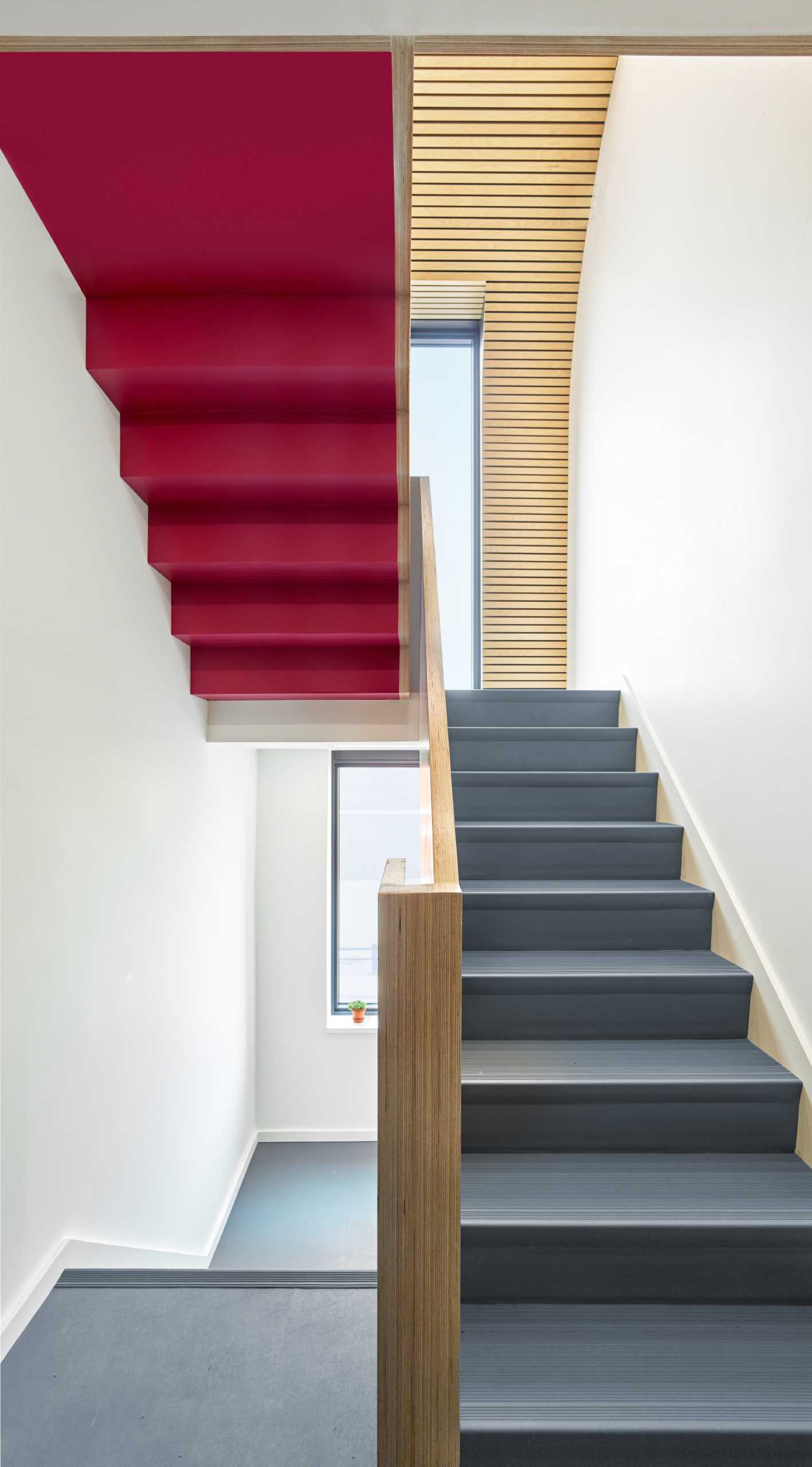 The central staircase thematically connects all floors in this office building with Baltic birch slats and graphic floor numbers that lead to Dubbeldam’s top-floor studio.