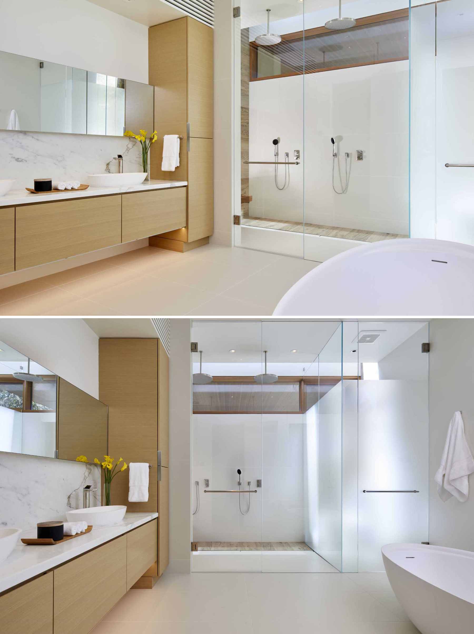 A primary bathroom featuring wood cabinetry, a freestanding bathtub, and a glass-enclosed double shower.