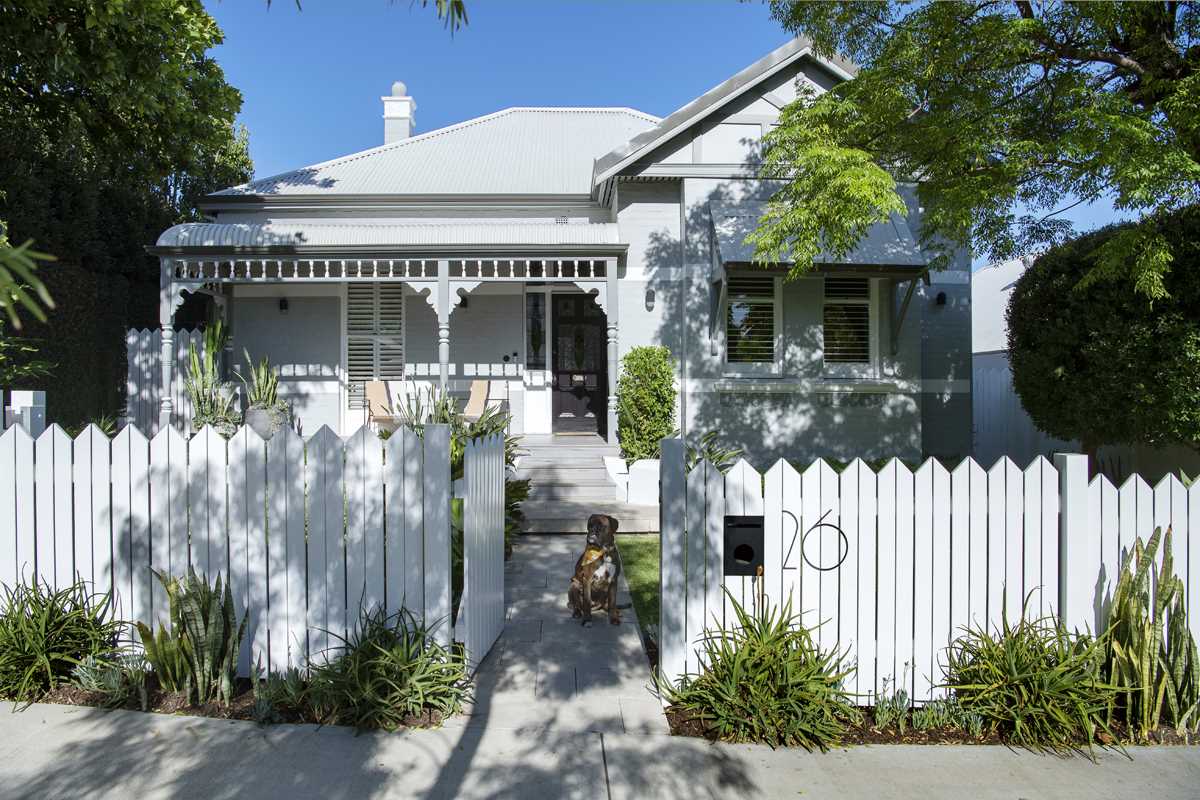 An Australian home with a white exterior and interior, and rear addition.