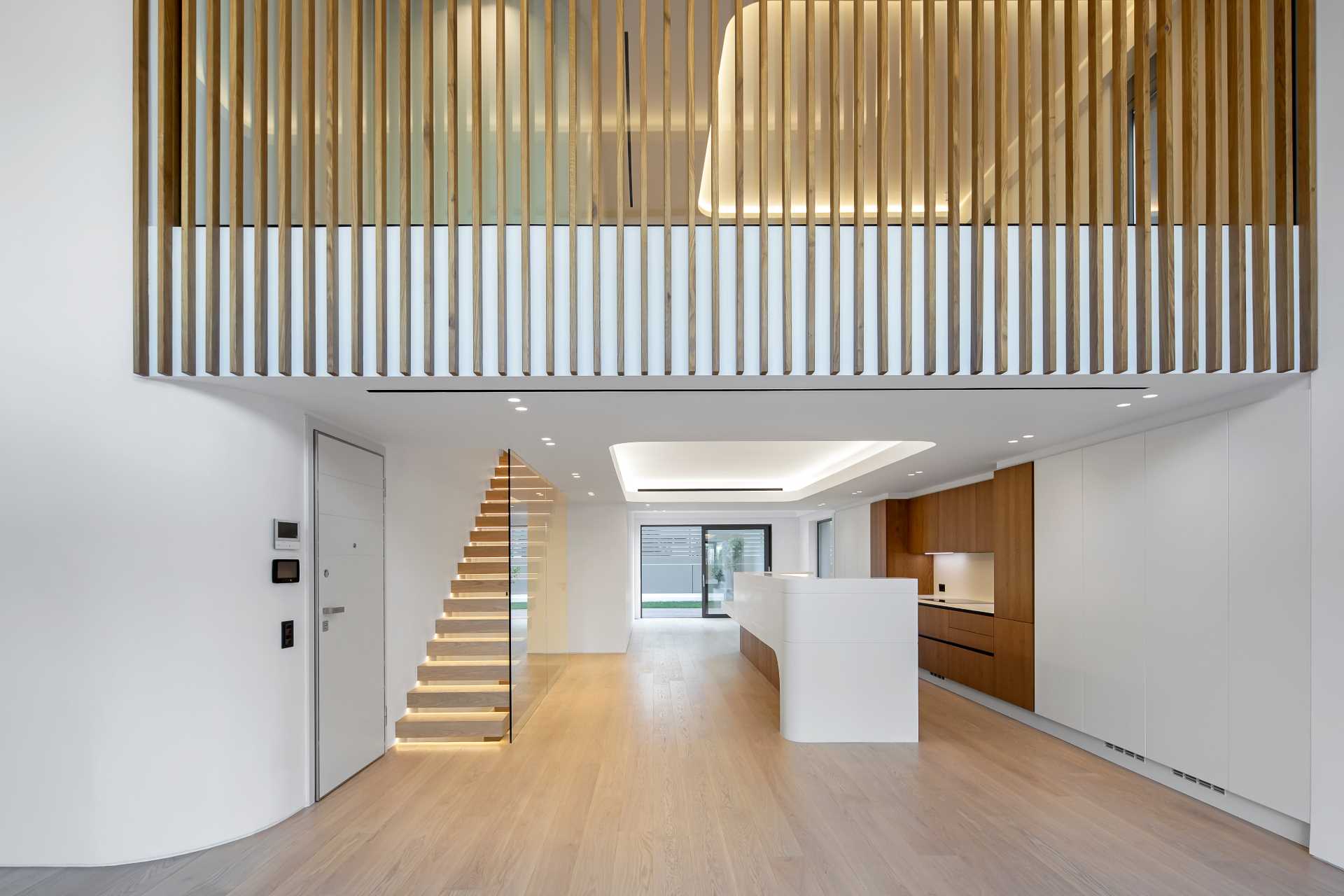 A modern white interior with wood accents and flooring.