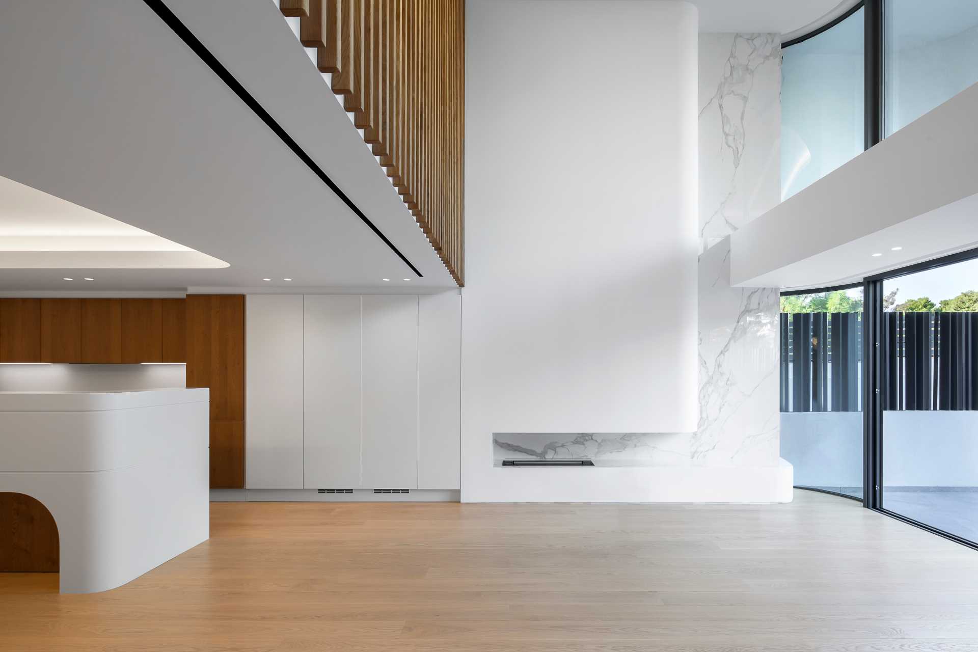 A modern white interior with wood accents and flooring.