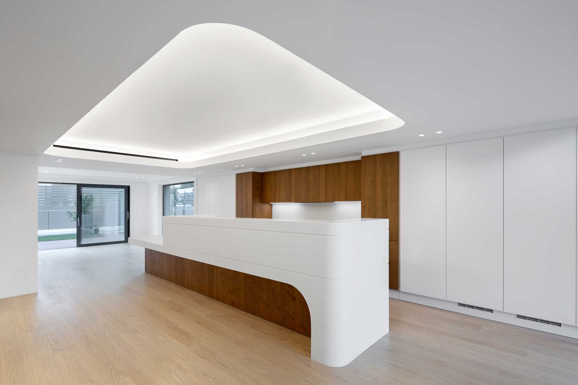 A modern wood and white kitchen.