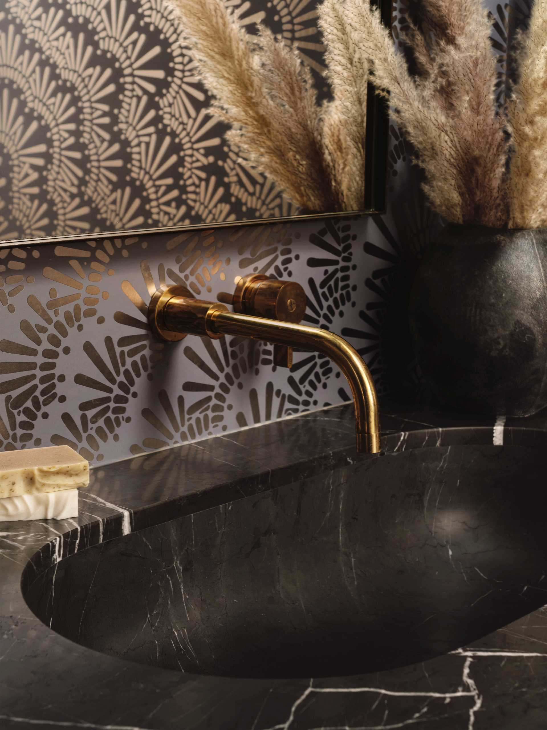 In this bathroom, a fun metallic wallpaper creates a unique look and complements the fixtures.