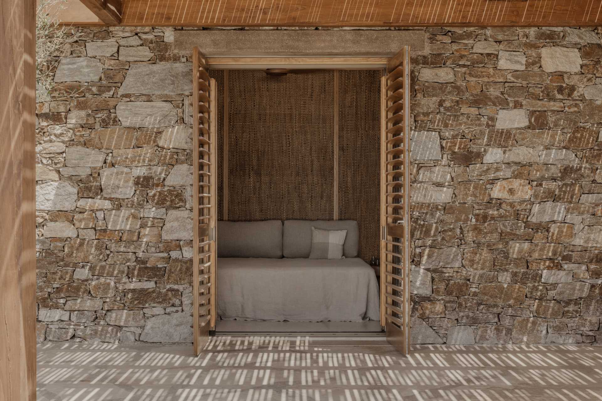 A modern bedroom with doors that open to a terrace.