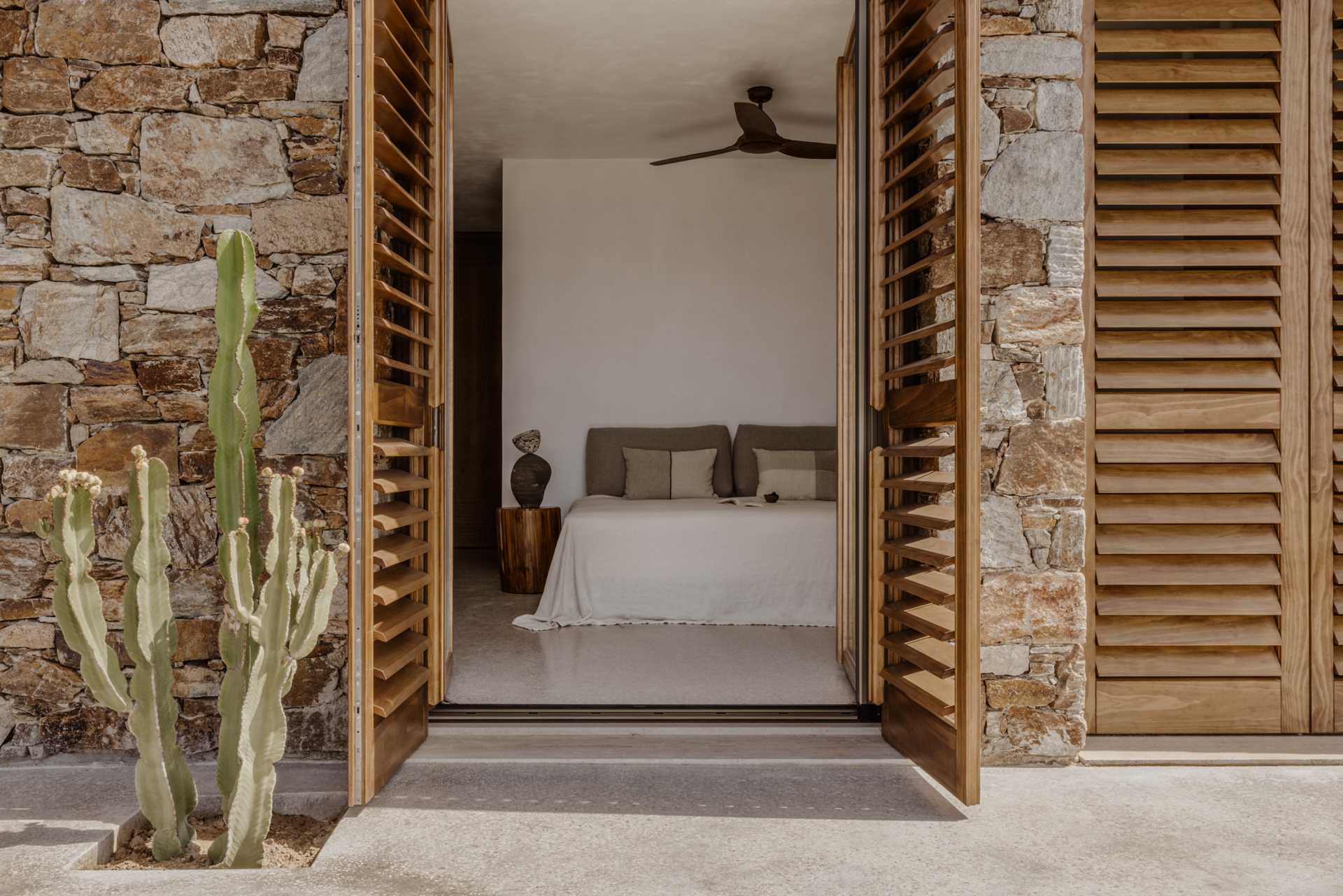 A modern bedroom with doors that open to a terrace.