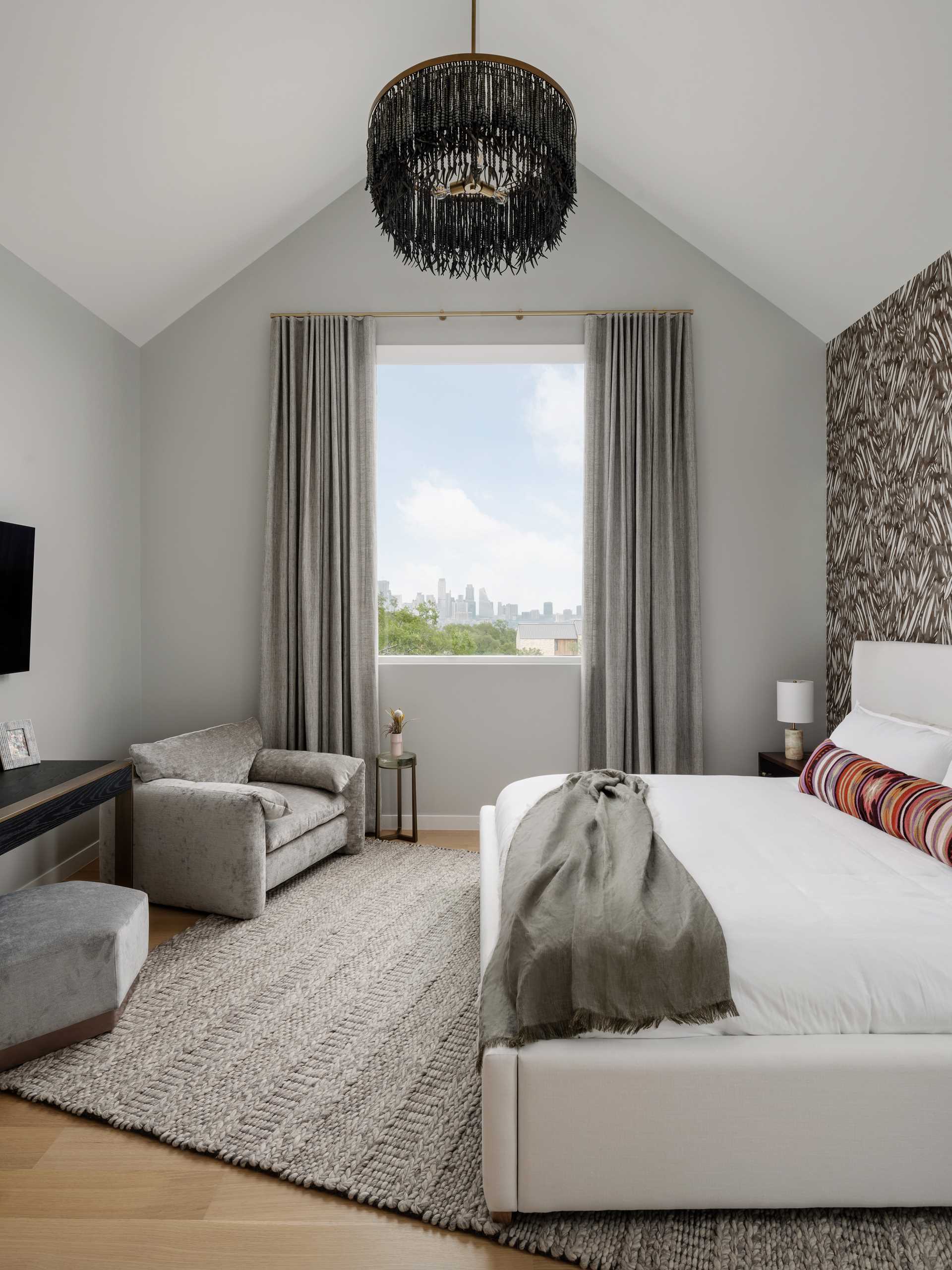 In the second bedroom, the ceiling follows the gabled roof form.