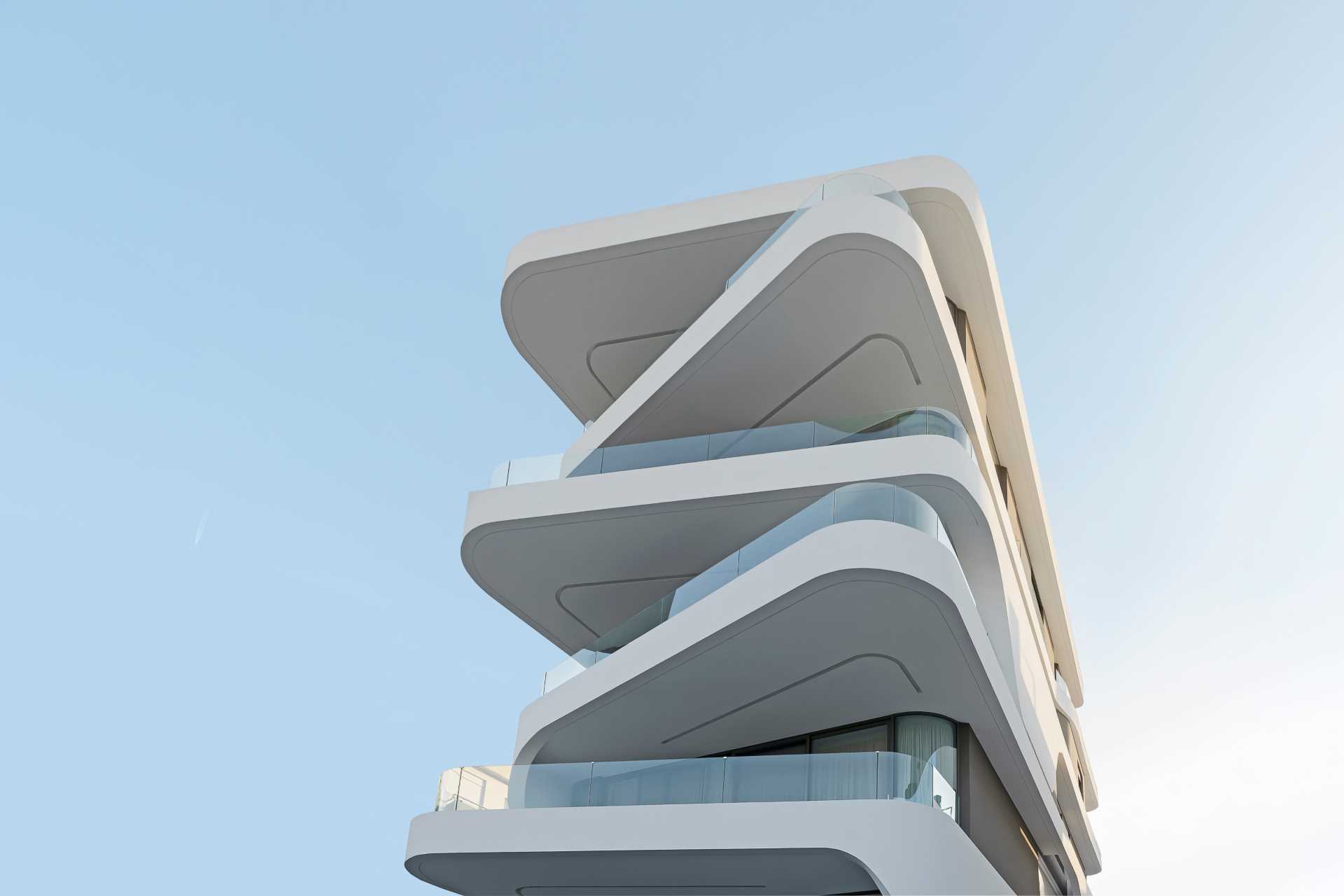 Key to the design of this modern apartment building are the curvilinear balconies that alternate directions creating a lively facade.