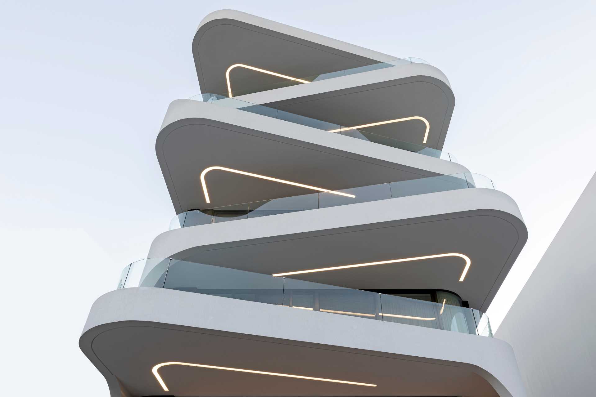 Key to the design of this modern apartment building are the curvilinear balconies that alternate directions creating a lively facade.