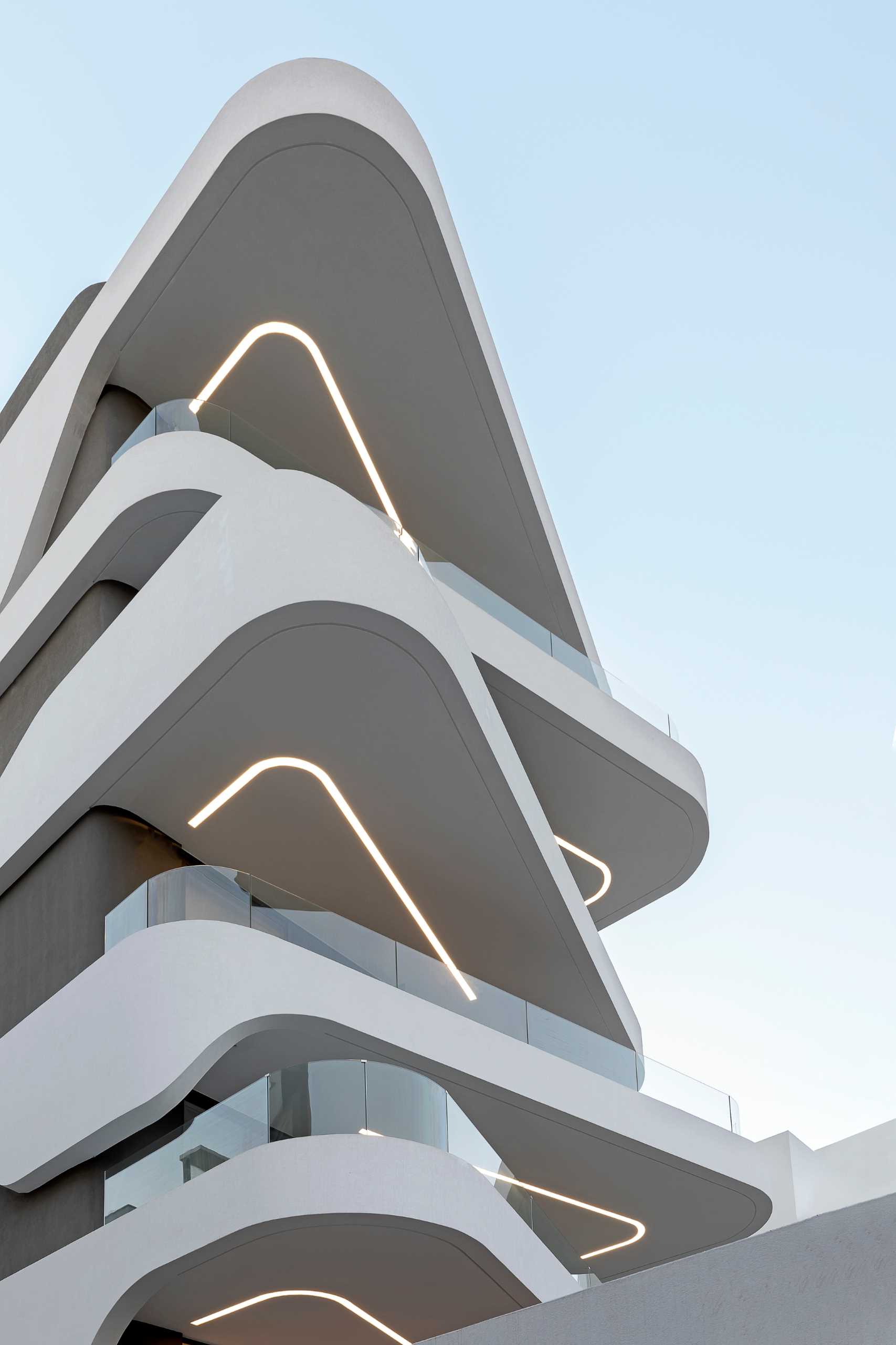 Key to the design of this modern apartment building are the curvilinear balconies that alternate directions creating a lively facade.