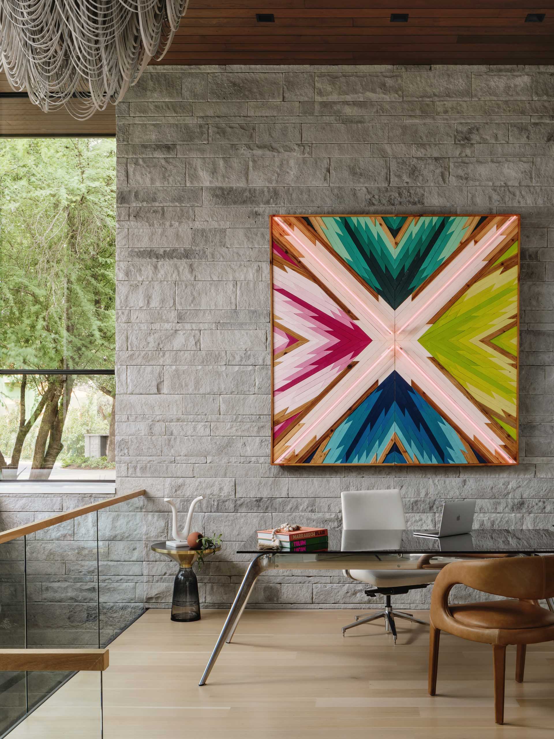 Bright and colorful artwork hangs on the wall in the home office.