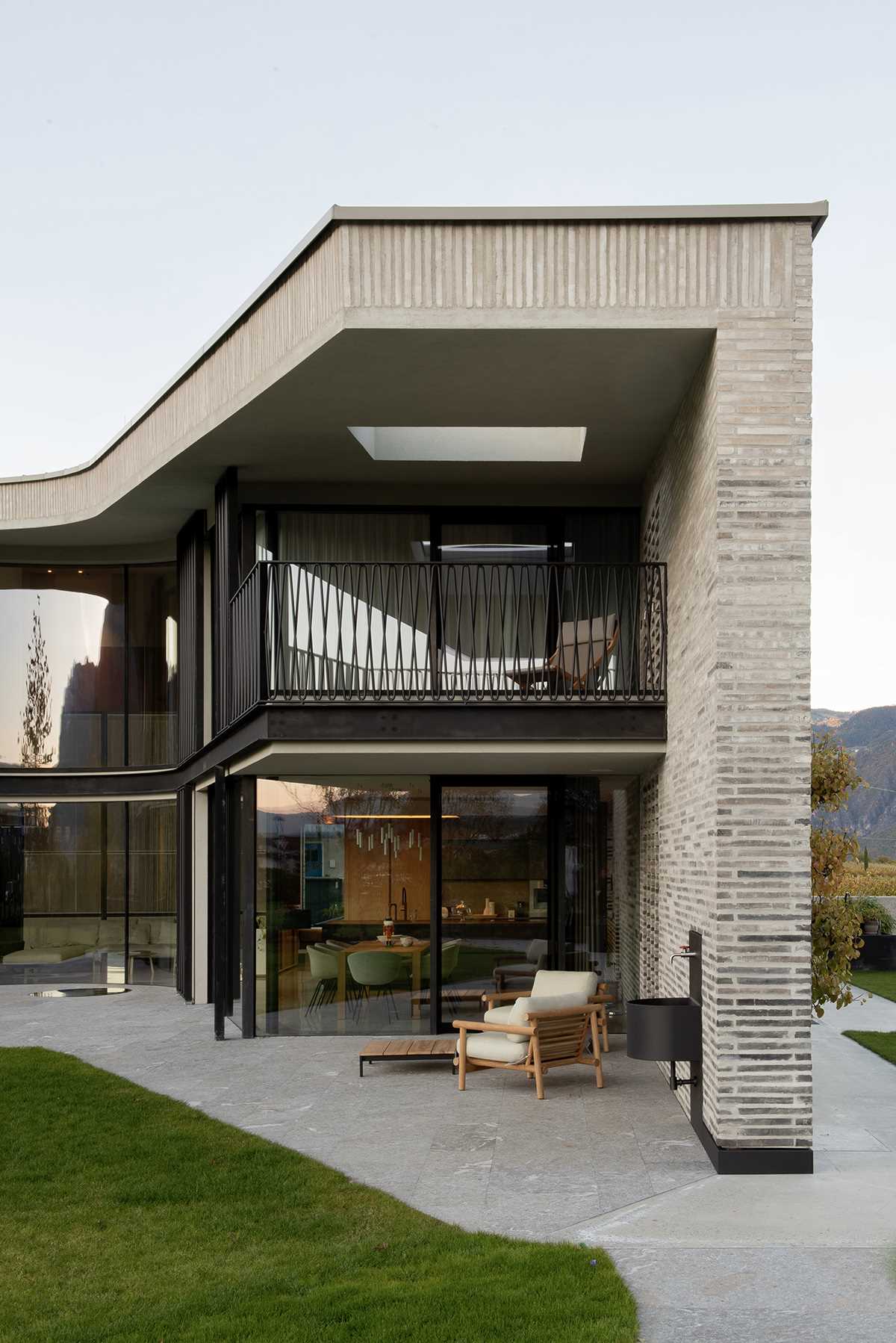 A modern home features handmade elongated bricks ranging from dark to light.