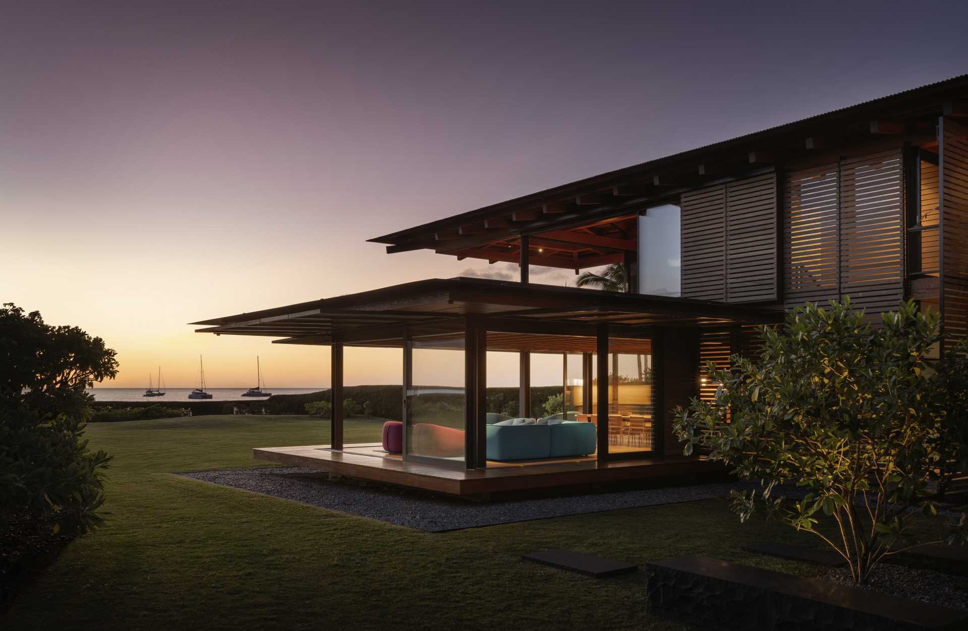 Wooden floors extend from the living room to an exterior lanai that floats like a raft above the landscape.