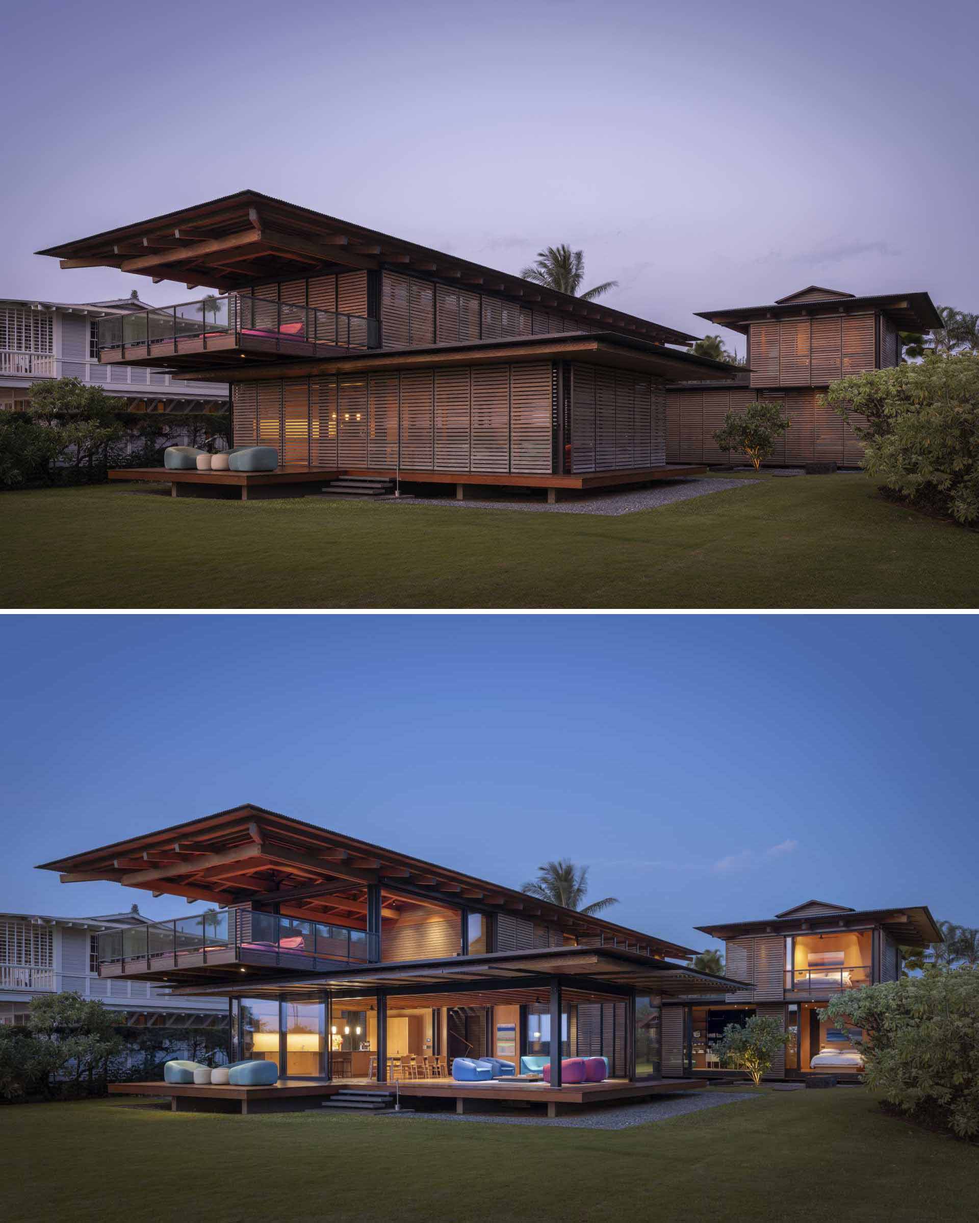 This modern home has flip-up vertical shutters that reveal an open kitchen, dining, and living room.