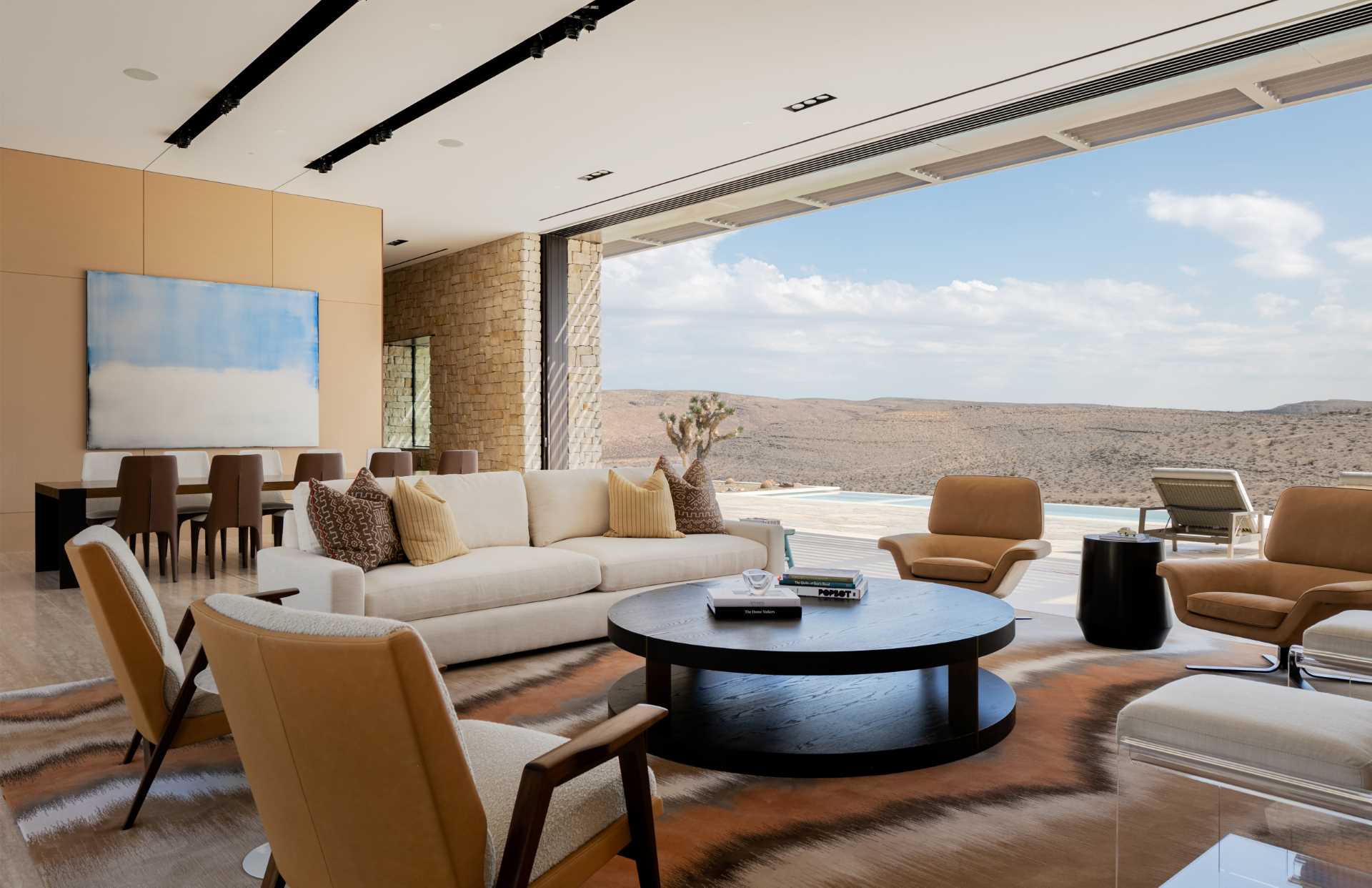 In the living room, the sliding glass panel walls, that measure in at 38 feet long by 13 feet high, provide panoramic views from both the north and south facades.