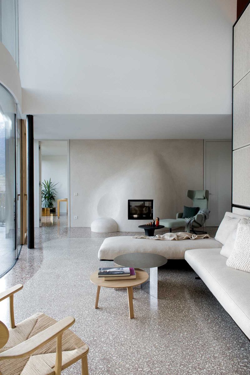 A modern living room with a sculptural fireplace surround.