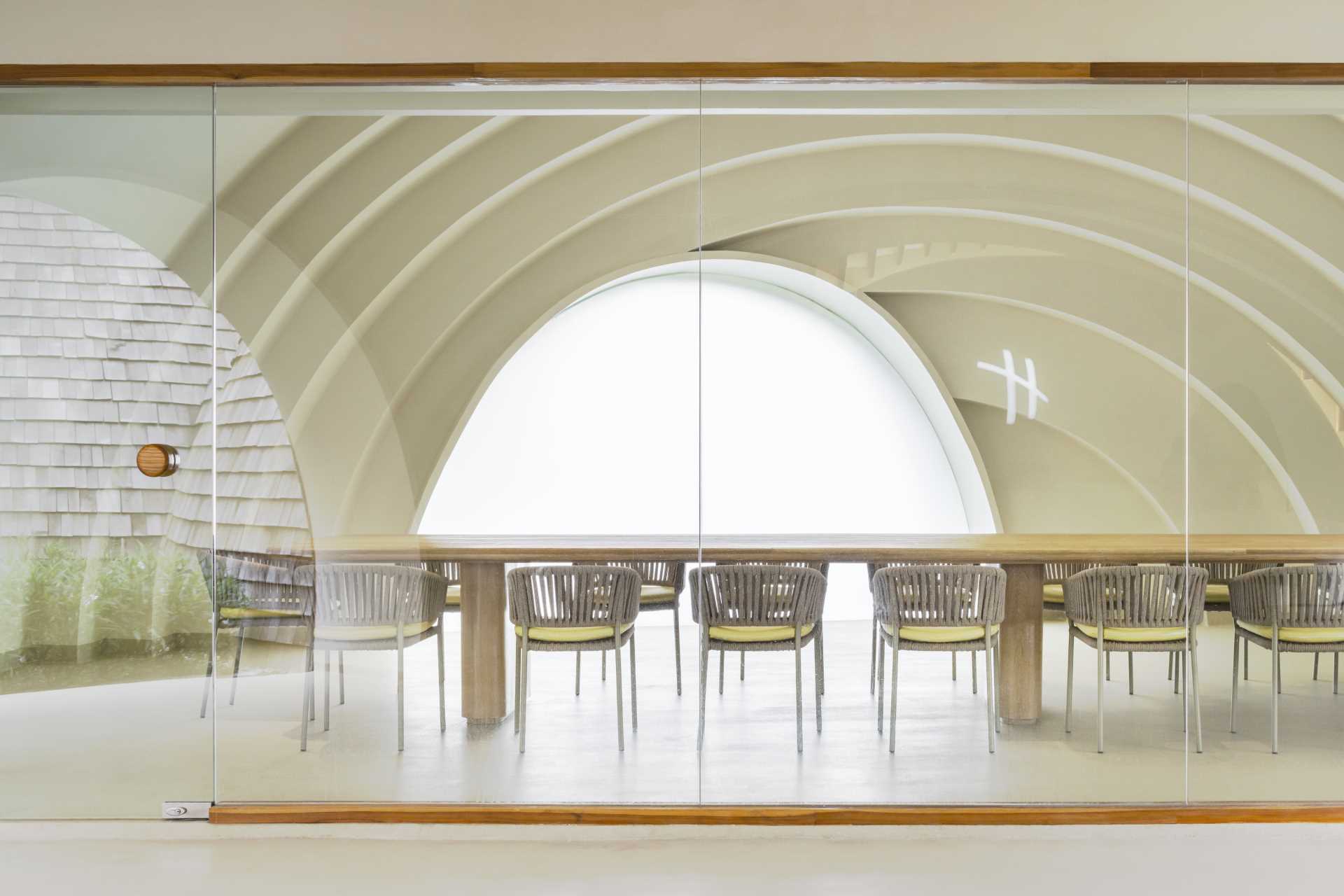A glass-enclosed conference room that enjoys views of the curved interior.