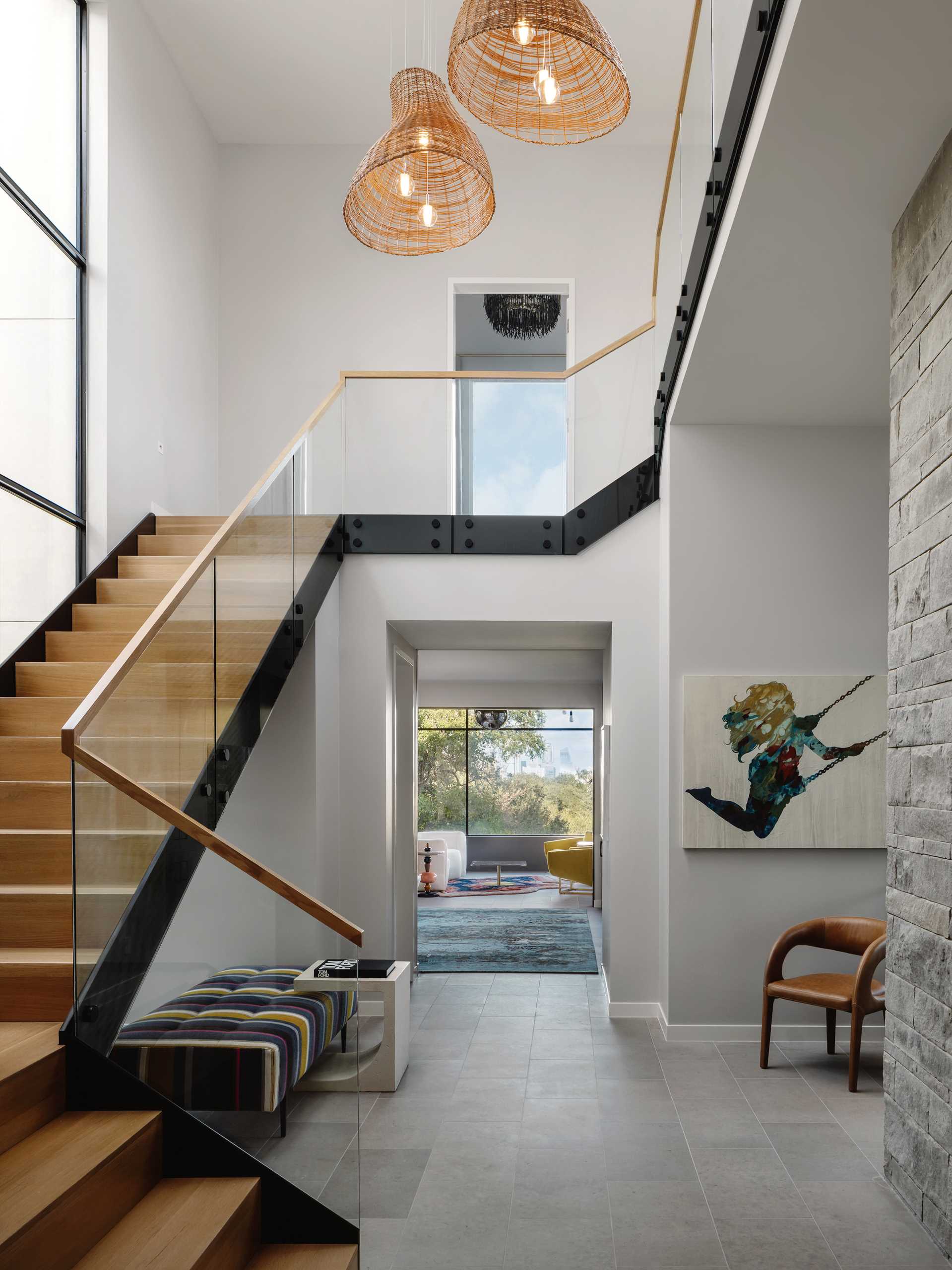 Metal and wood stairs connect the various levels of the home, while a seating area has been added underneath.