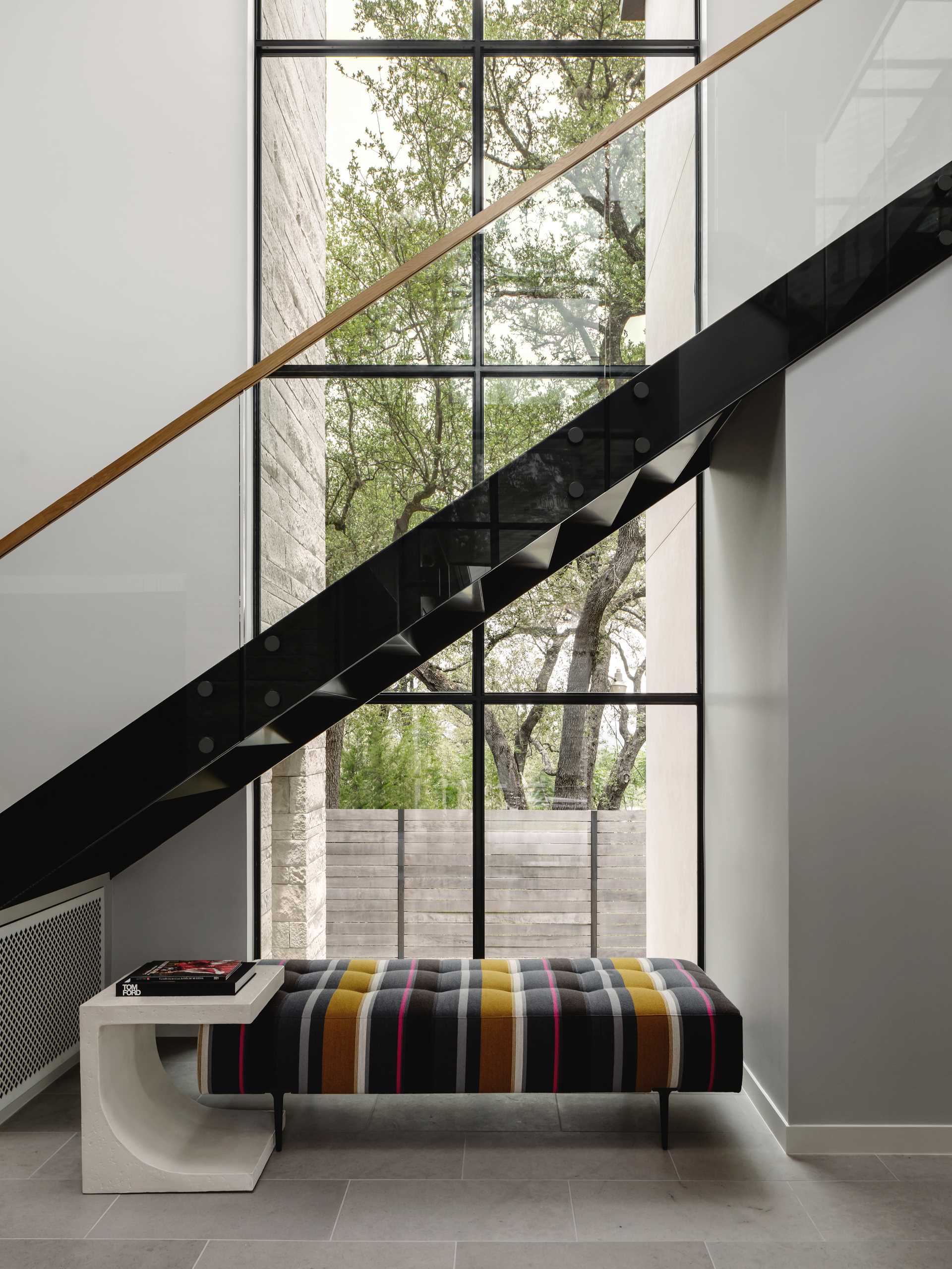 Metal and wood stairs connect the various levels of the home, while a seating area has been added underneath.