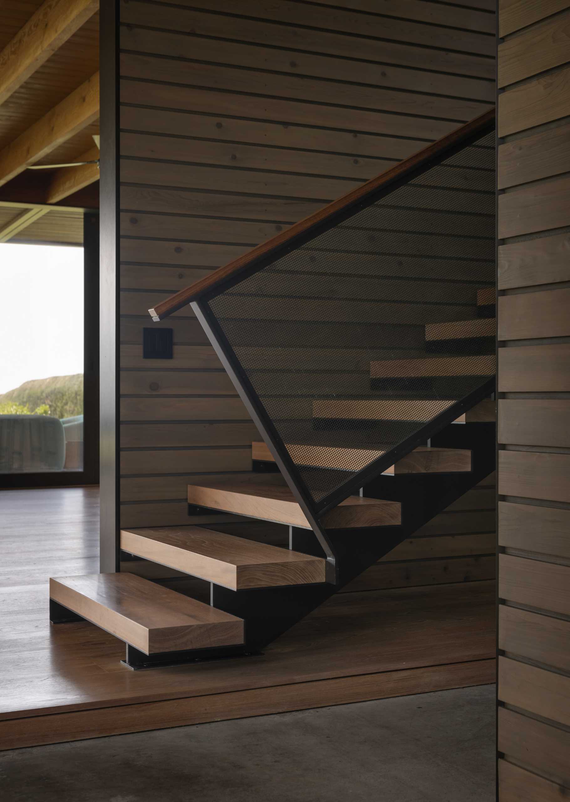 A modern home with wood and metal stairs.