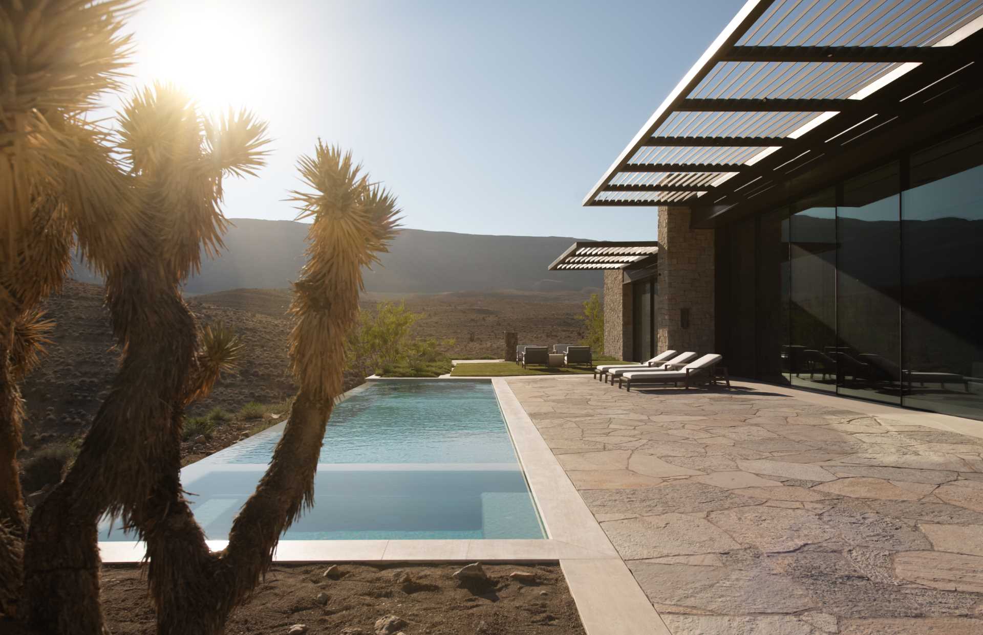 A modern desert home with a long swimming pool.