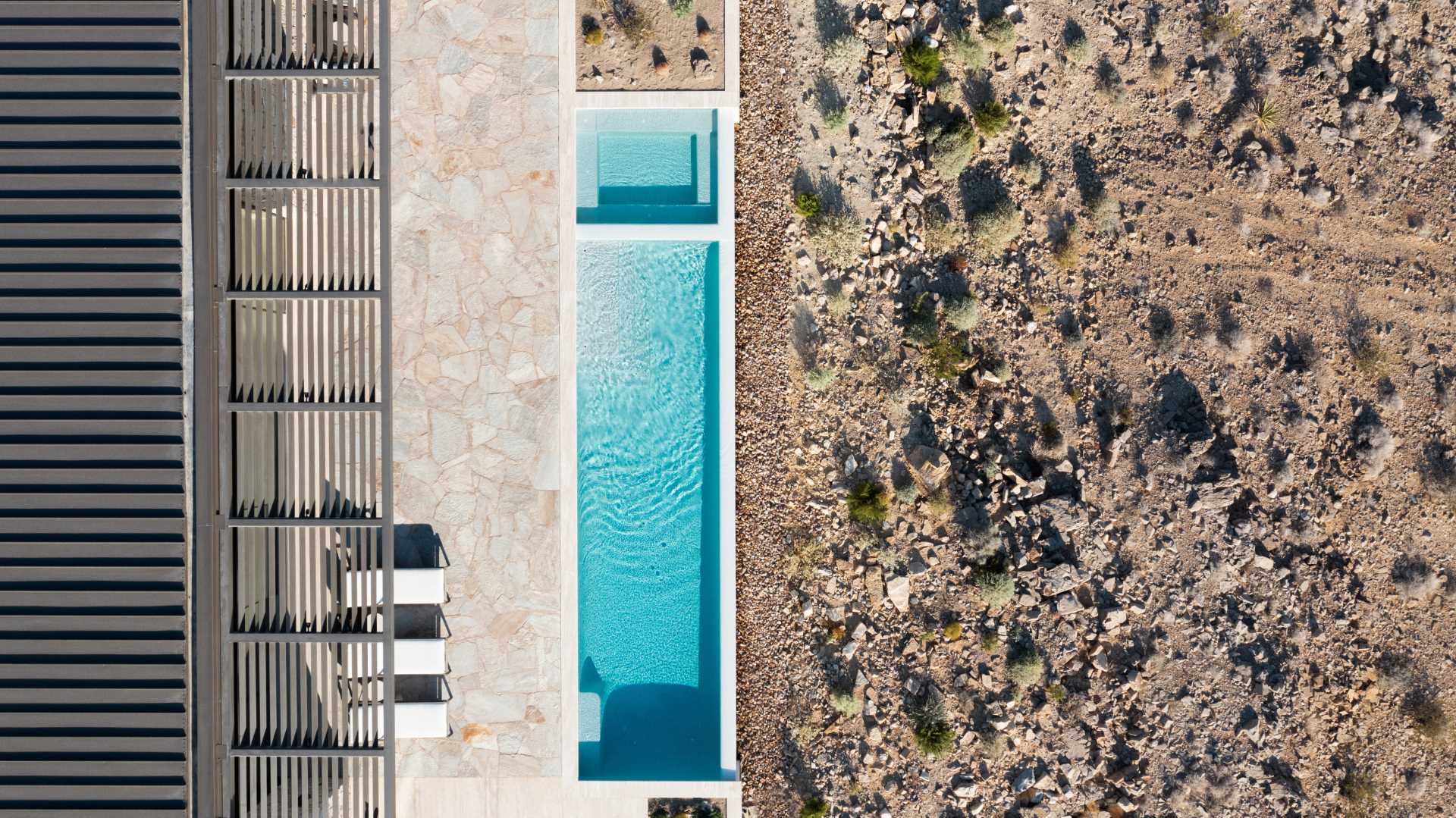 A modern desert home with a long swimming pool.