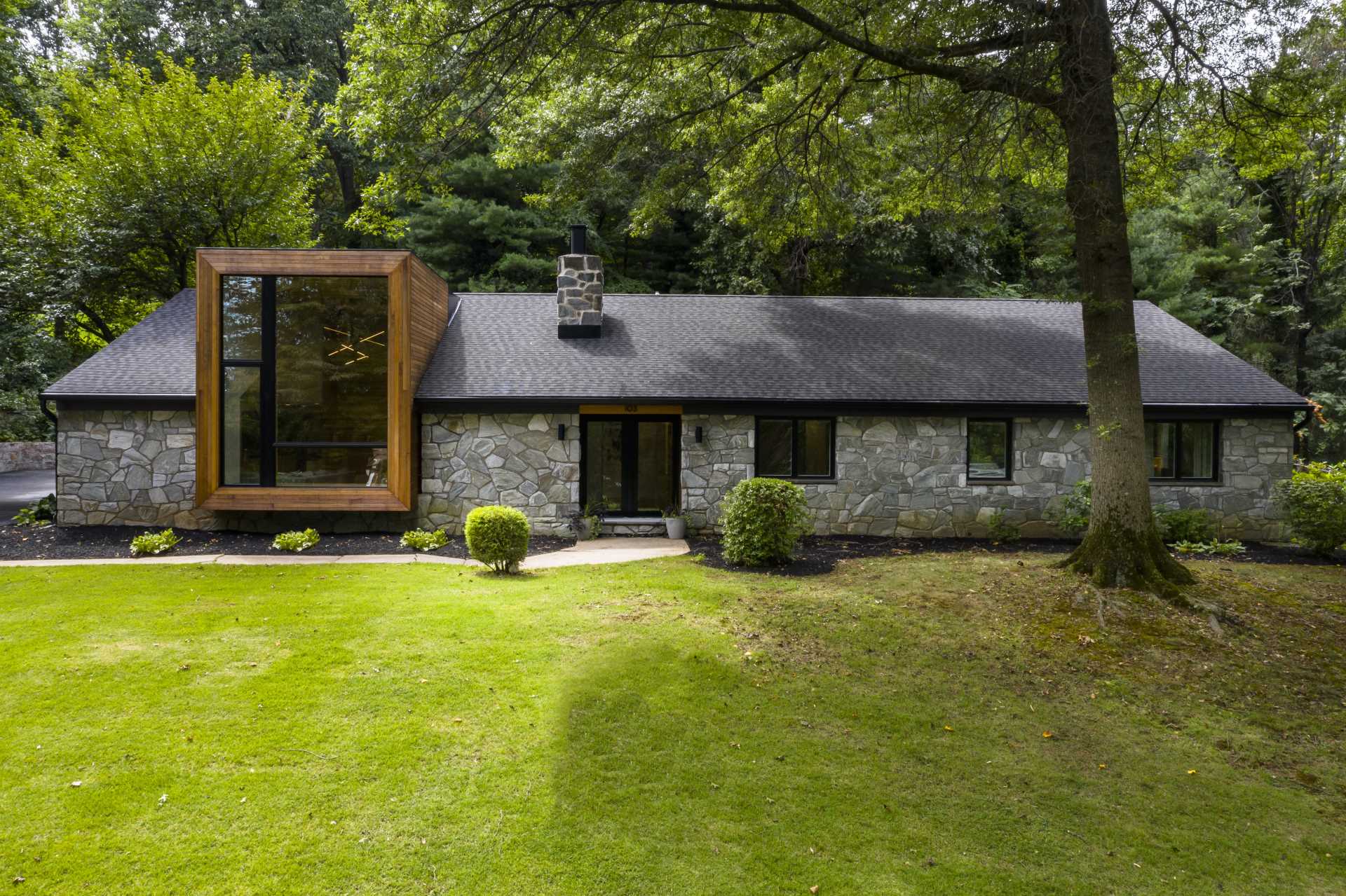 A remodeled 1950s ranch home with stone walls and a cedar-clad accent.