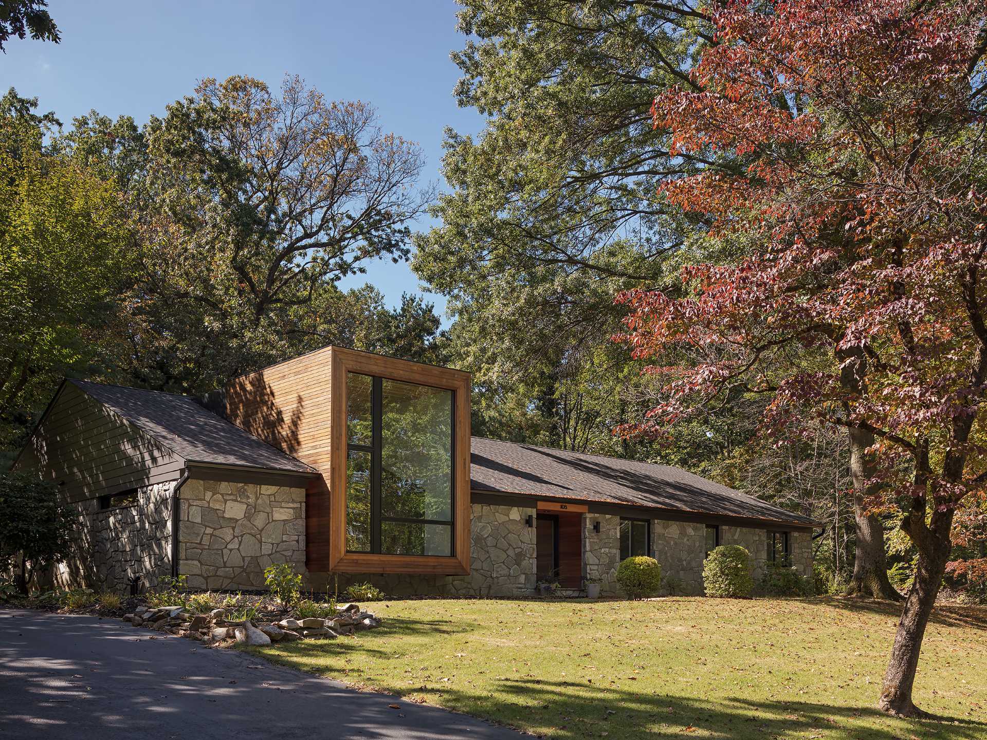 A remodeled 1950s ranch home with stone walls and a cedar-clad accent.