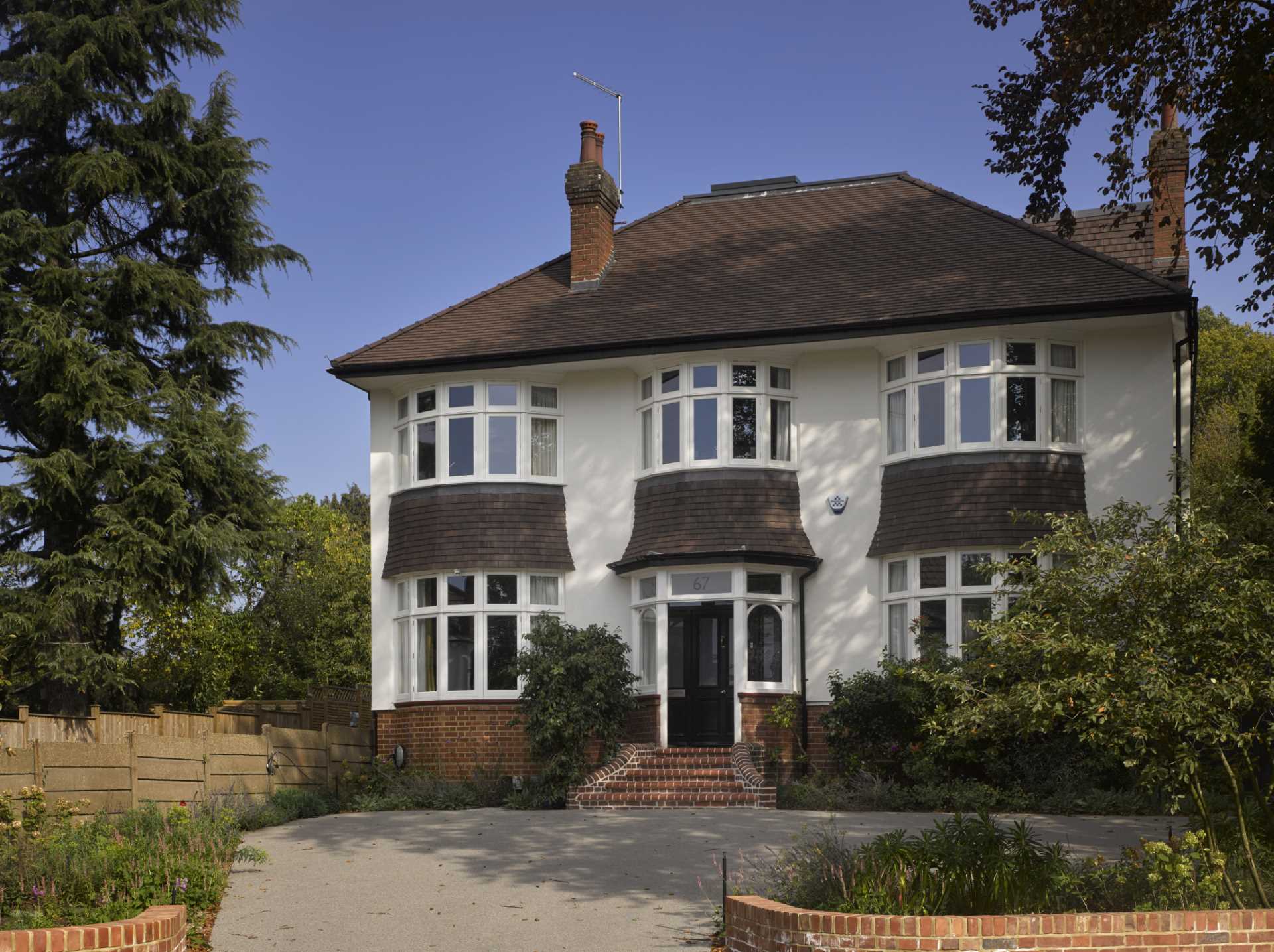 A 1920s British home received a modern rear addition with a sunken living room.