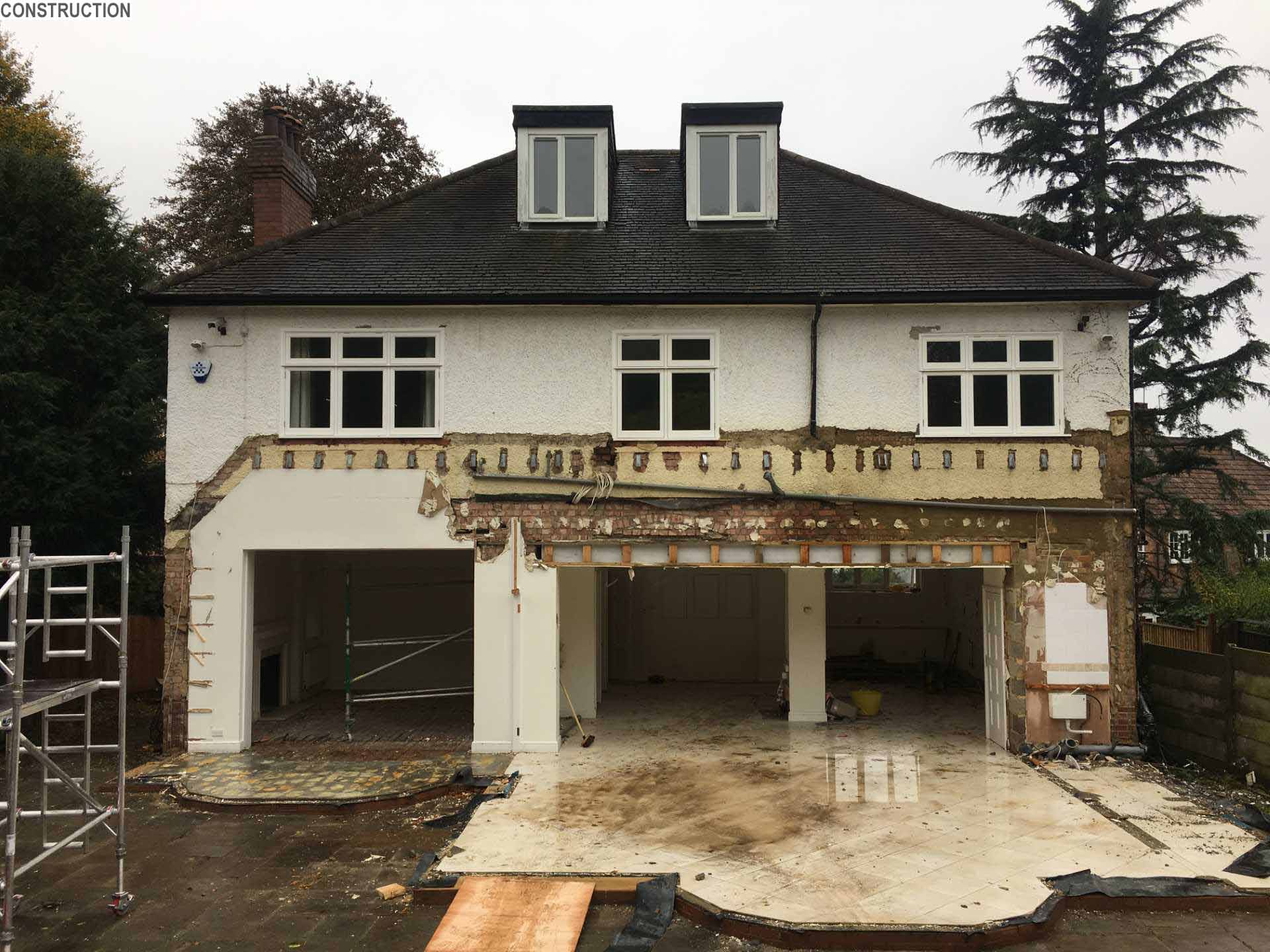 A 1920s British home received a modern rear addition with a sunken living room.