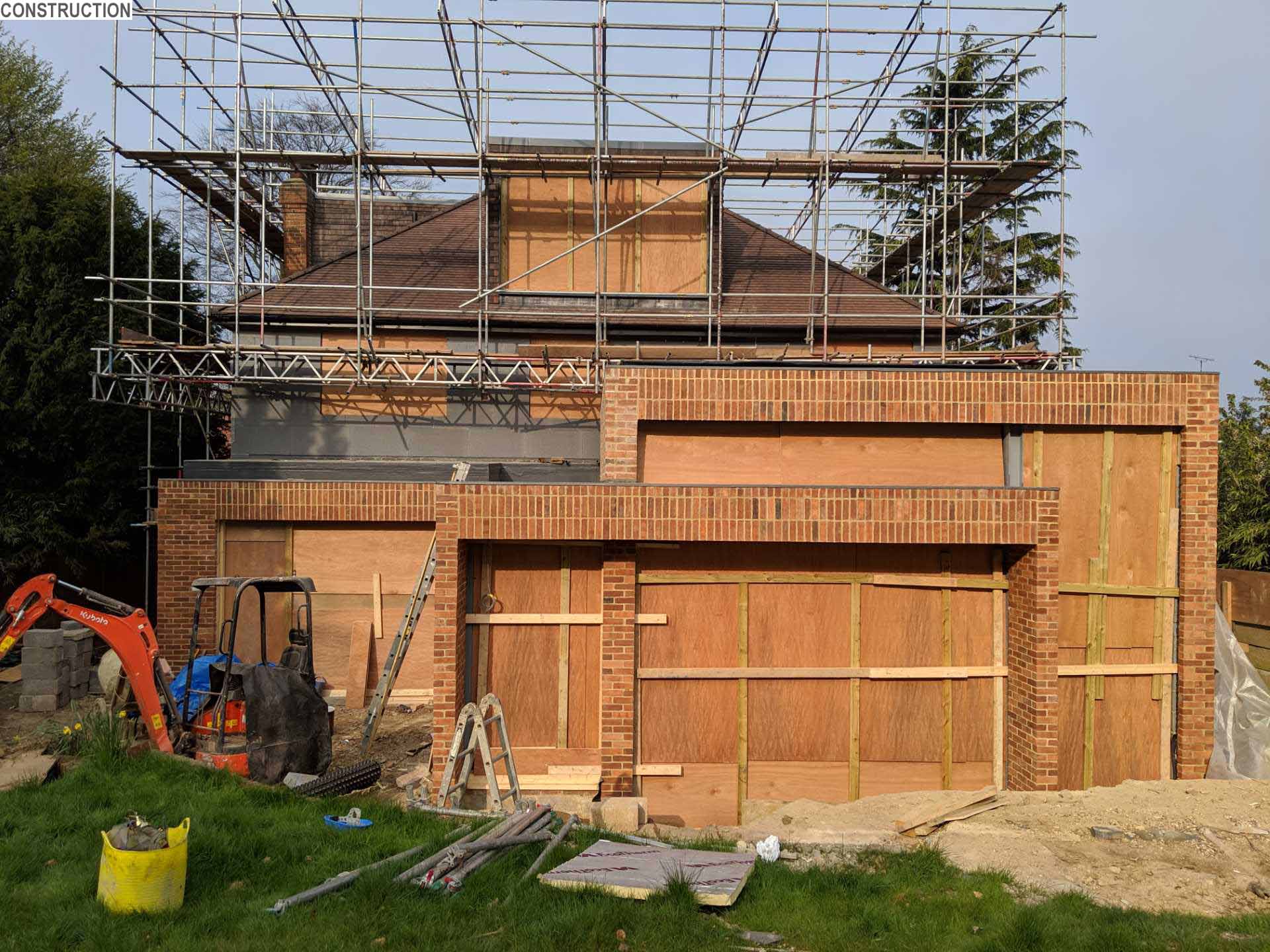 A 1920s British home received a modern rear addition with a sunken living room.