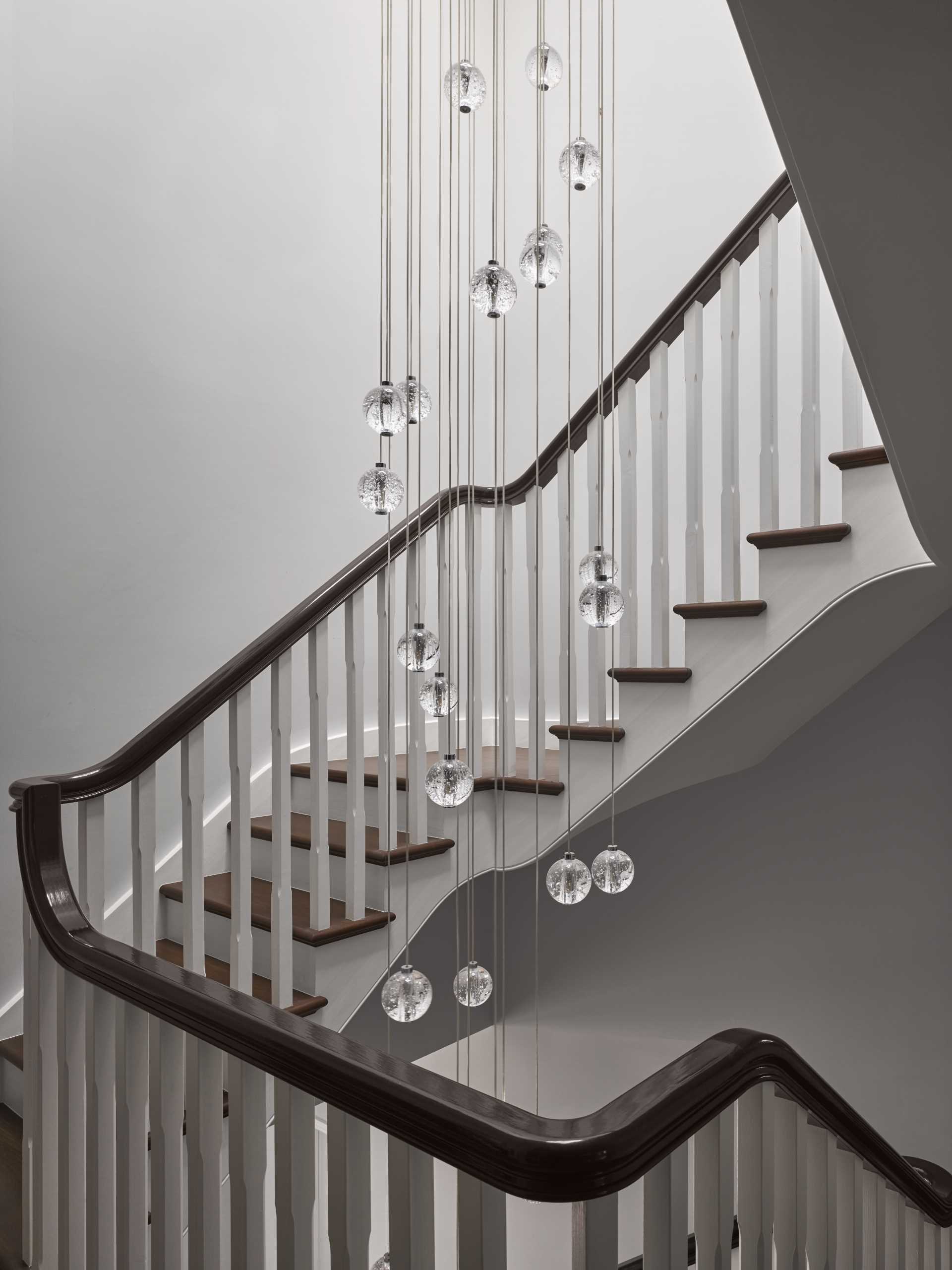 This staircase, which connects the various levels of the ،me, s،wcases a Bolla chandelier by Christopher Wray.