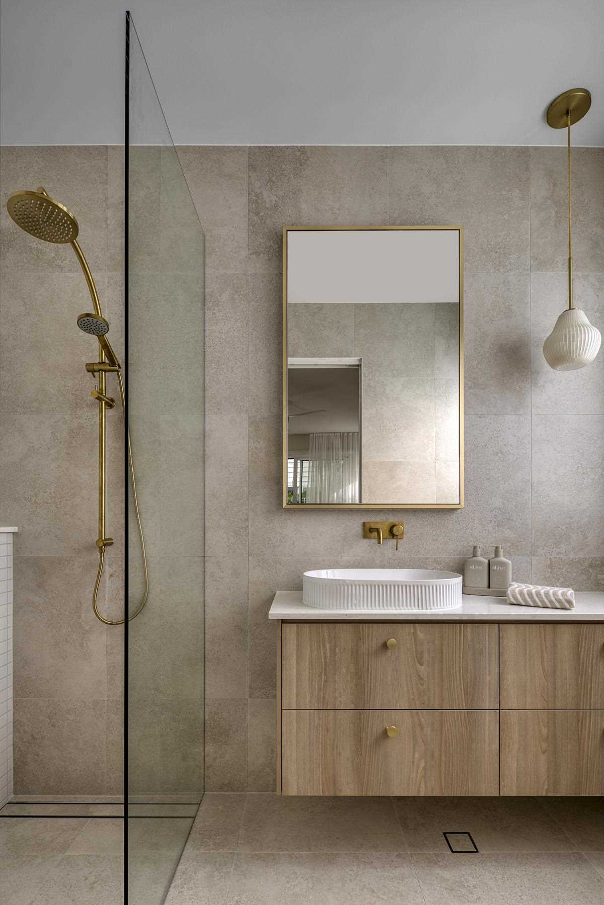 In this modern bathroom, natural elements, like wood and stone, have been paired with metallic accents for a contemporary look.