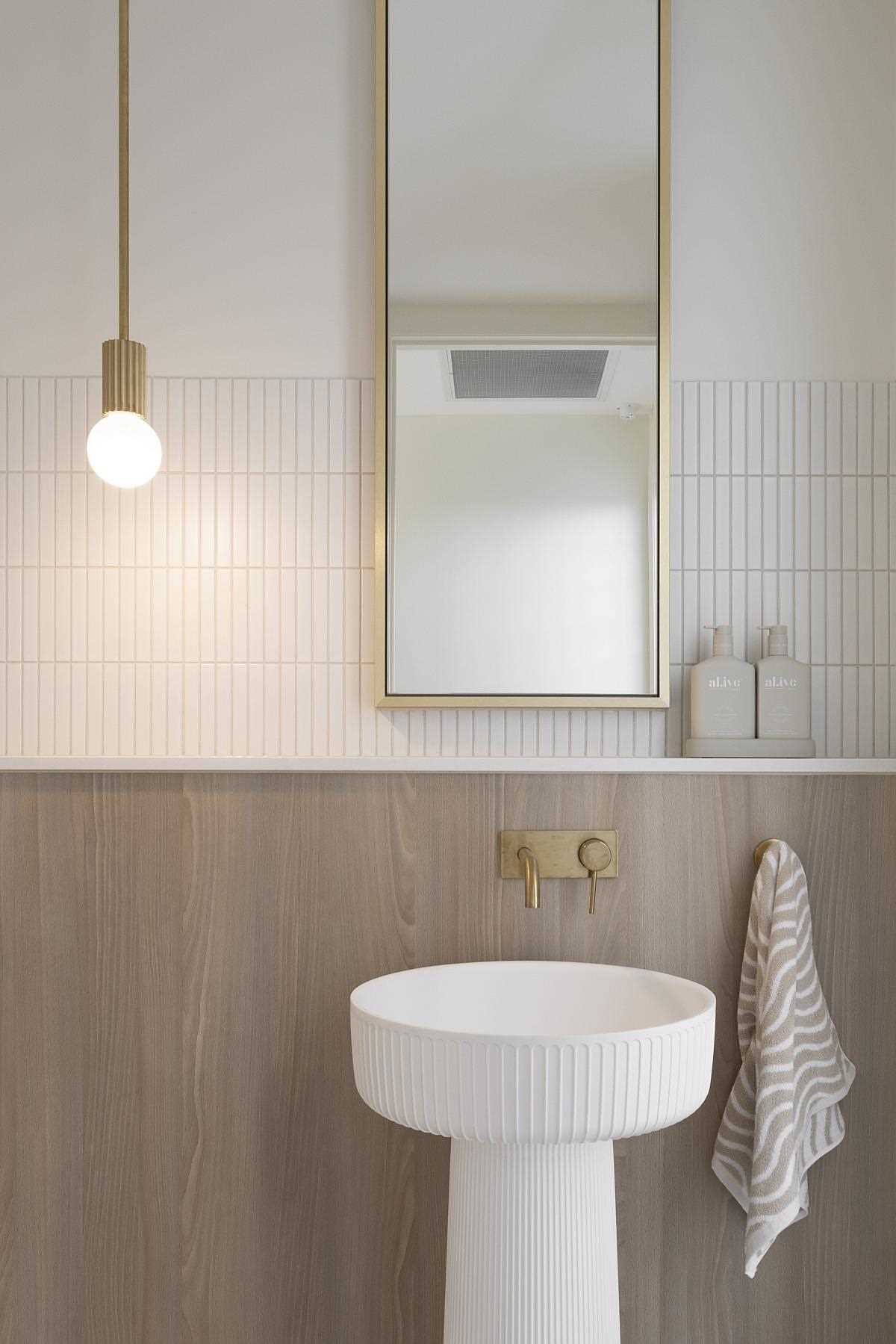 In this modern bathroom, natural elements, like wood and stone, have been paired with metallic accents for a contemporary look.