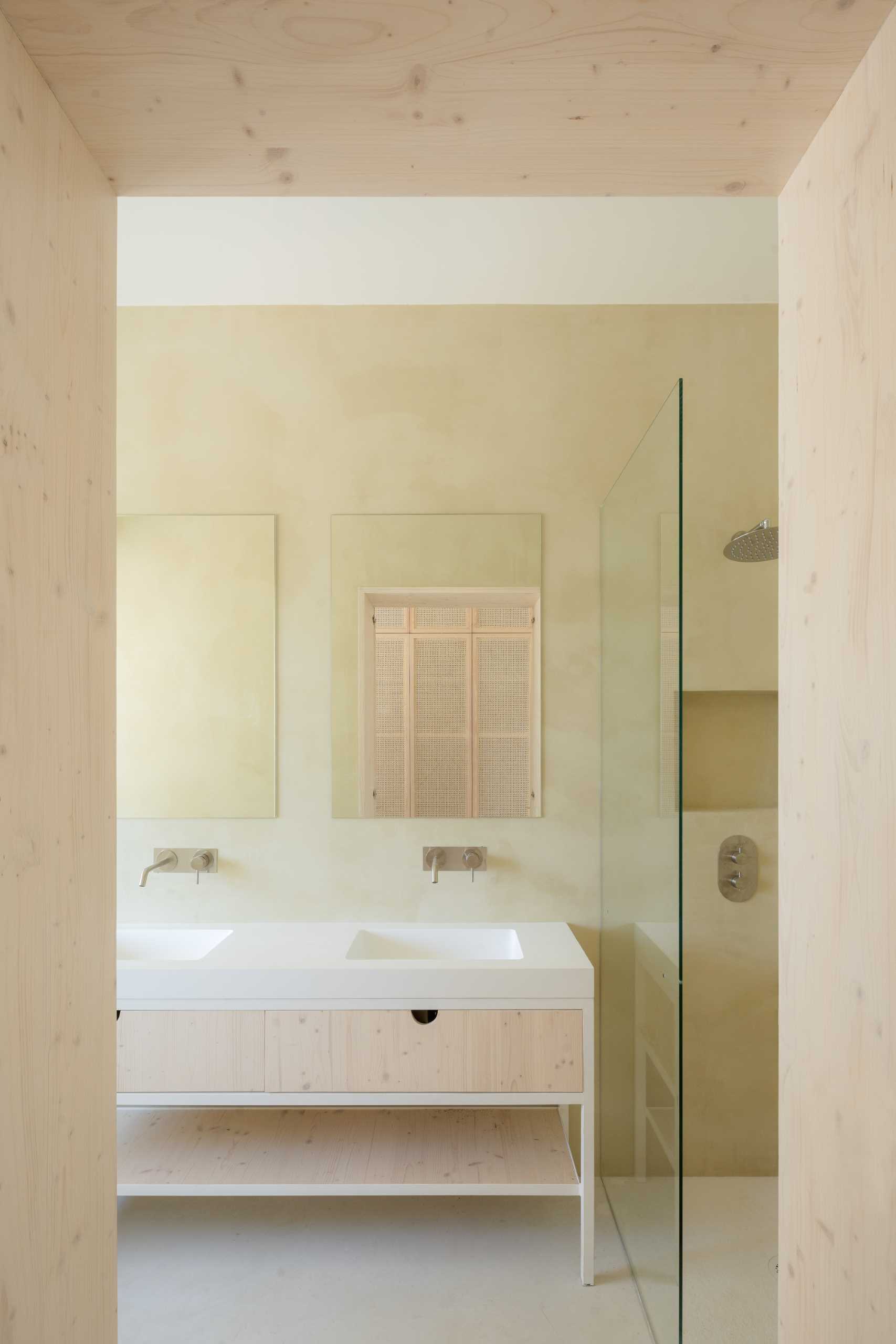 A modern bathroom features khaki-beige micro-cement.
