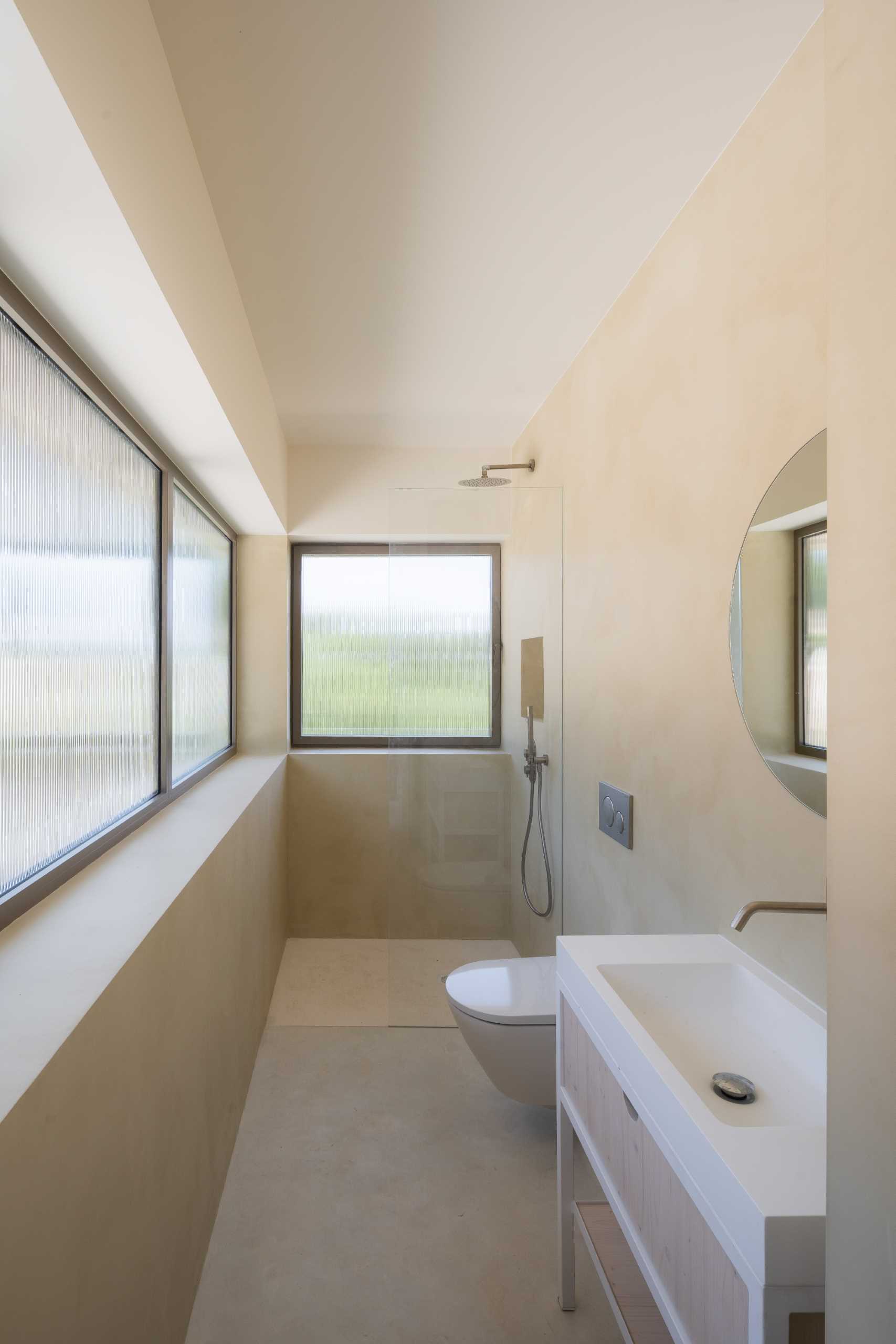 A modern bathroom features khaki-beige micro-cement.