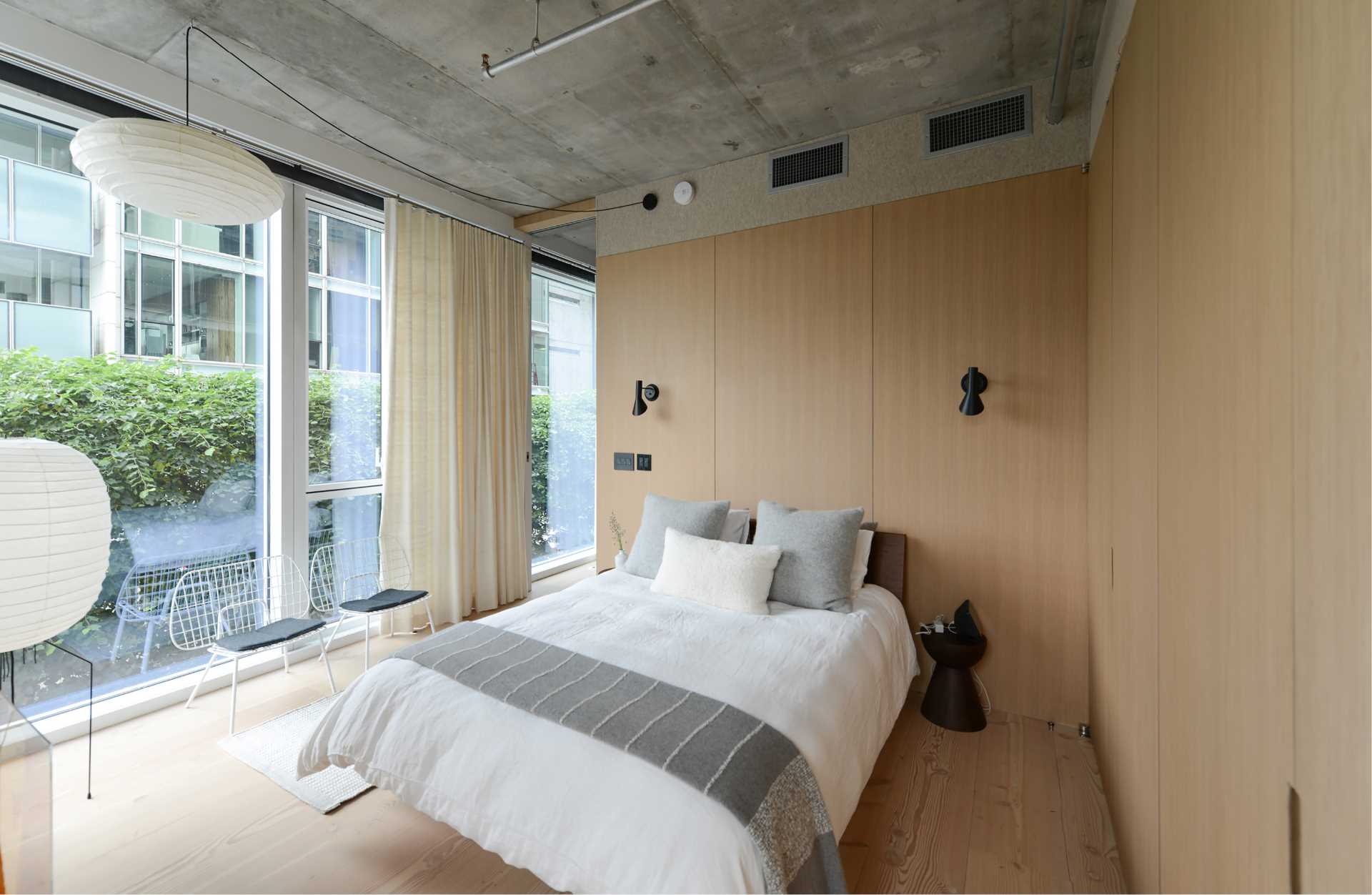 A modern bedroom filled with an abundance of natural light.